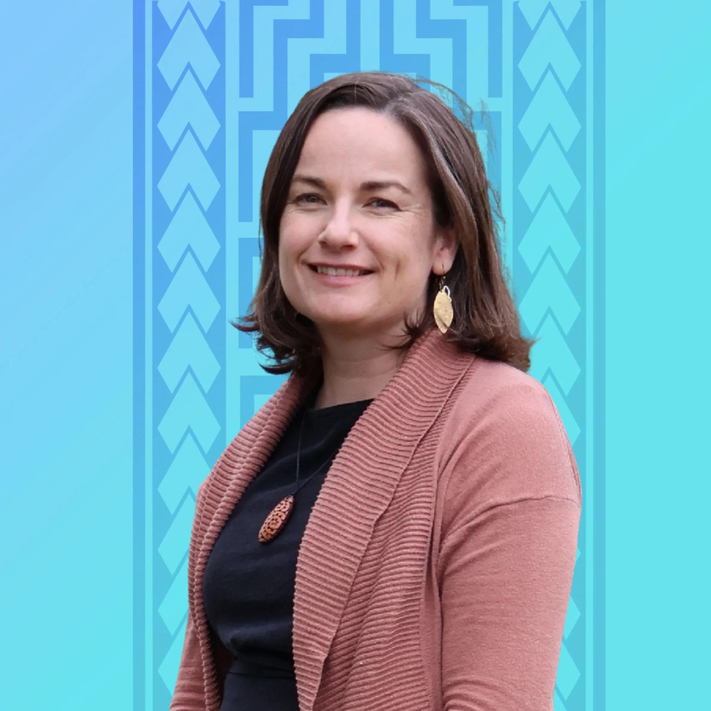 Photo of Ingrid Jones. Ingrid is a 40-year-old Pākehā woman with shoulder length brown hair. She is smiling at the camera.