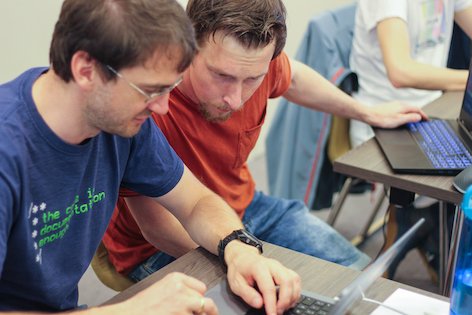 Christian and Günther working together at a laptop