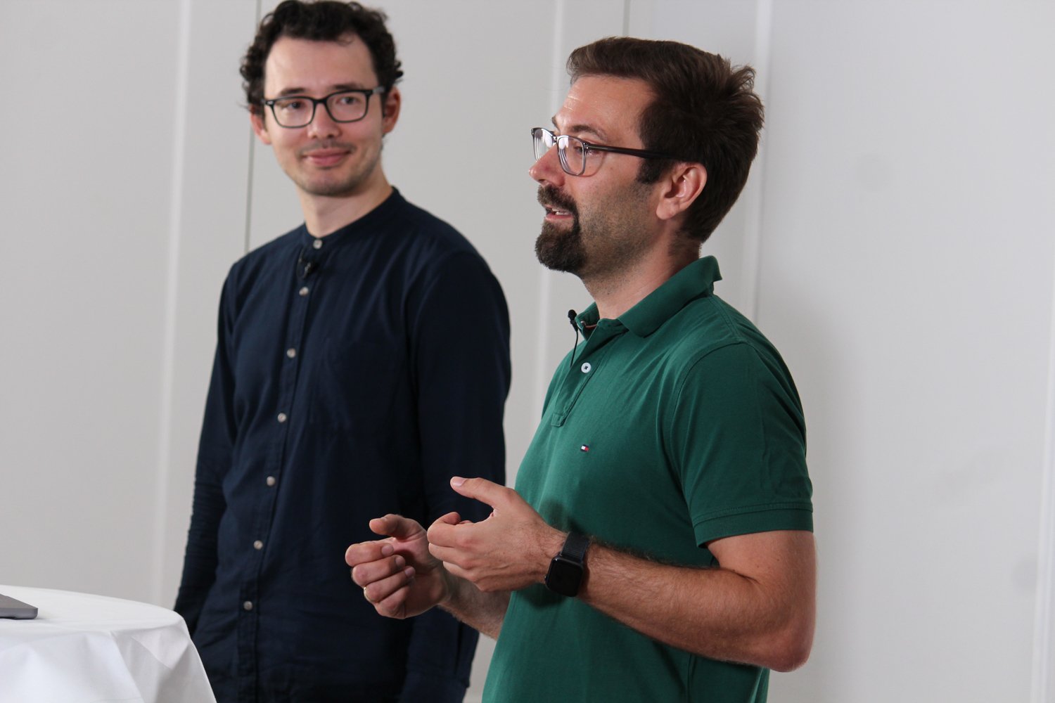 CTO Seb from the side, giving a presentation to an off-camera audience, Rinat standing next to him