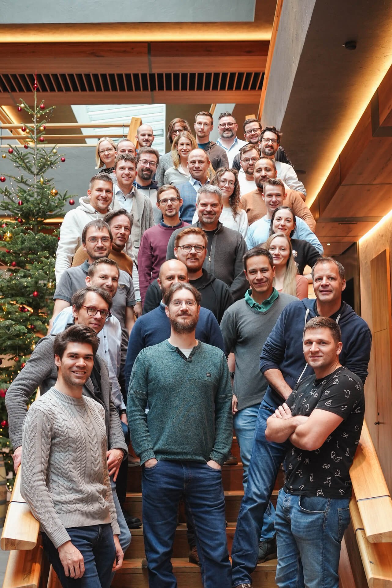 The Trustbit team posing during our 2022 company offsite, with a Christmas tree in the background