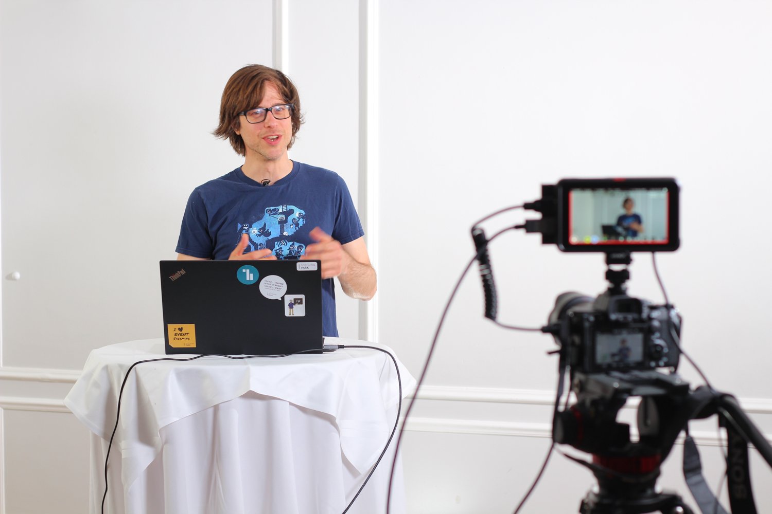 Daniel Weller being filmed while giving a talk