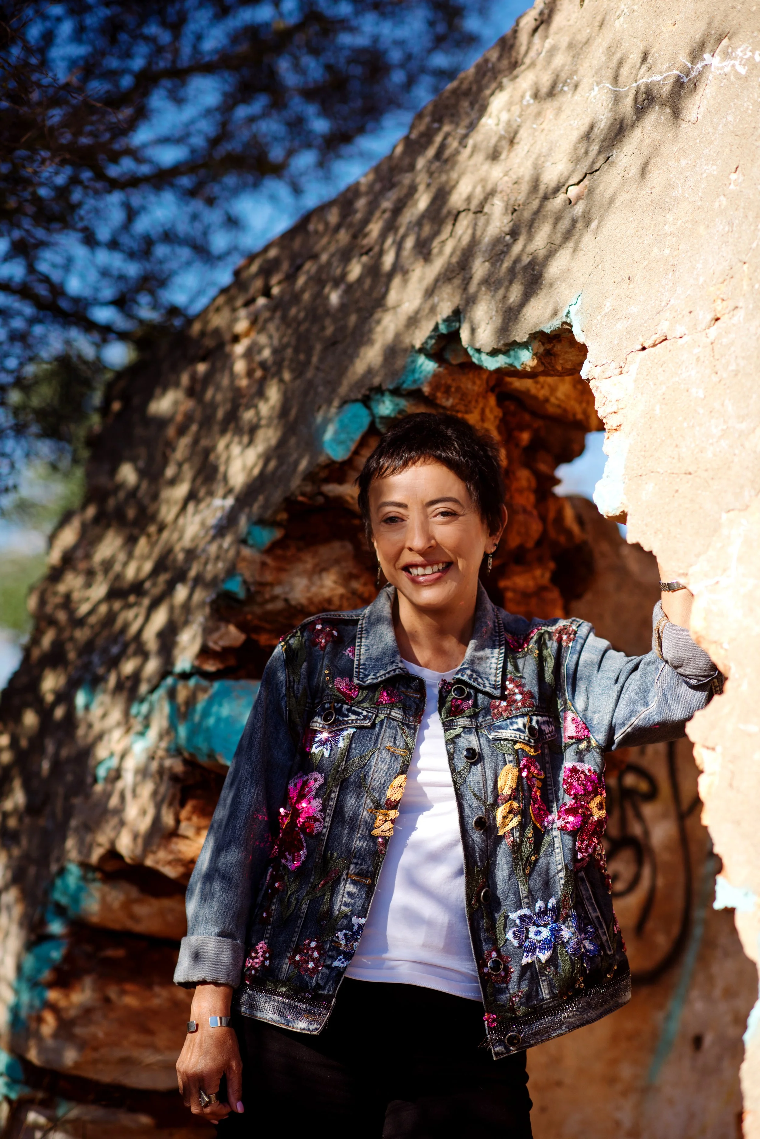 Alicia M Rodriguez standing near a ruin in the Algarve