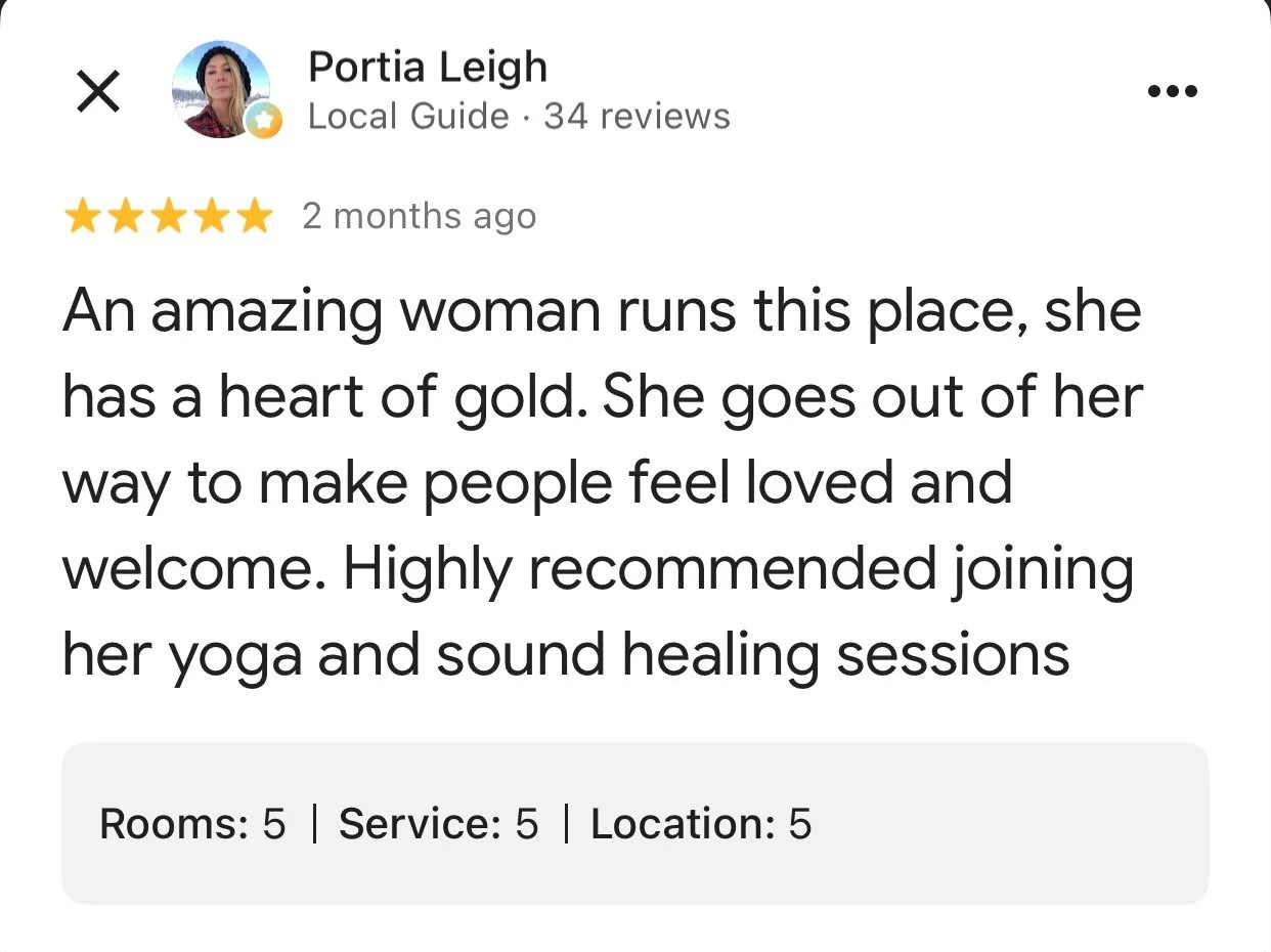 Screenshot of a Google review for a wellness or yoga center, praising the woman who runs the place and encouraging others to join her yoga and sound healing sessions.