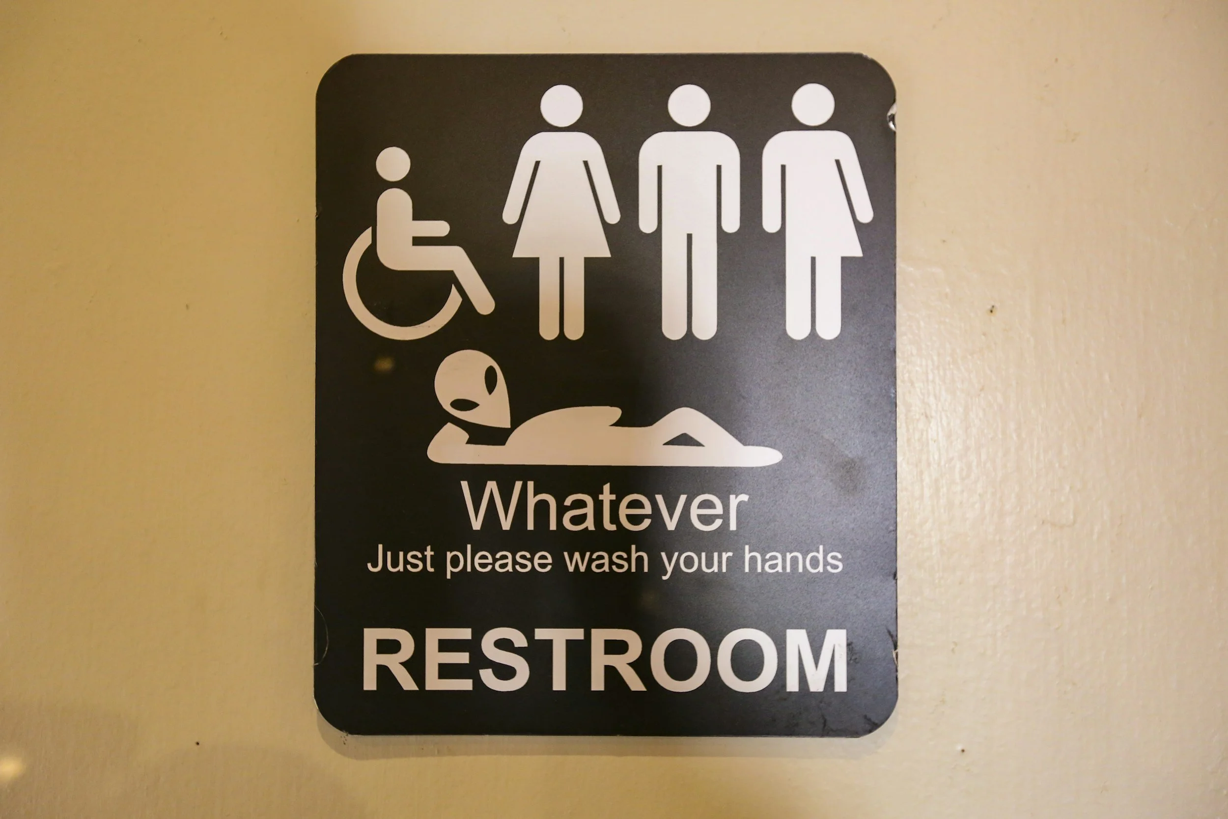 All gender restroom sign with alien