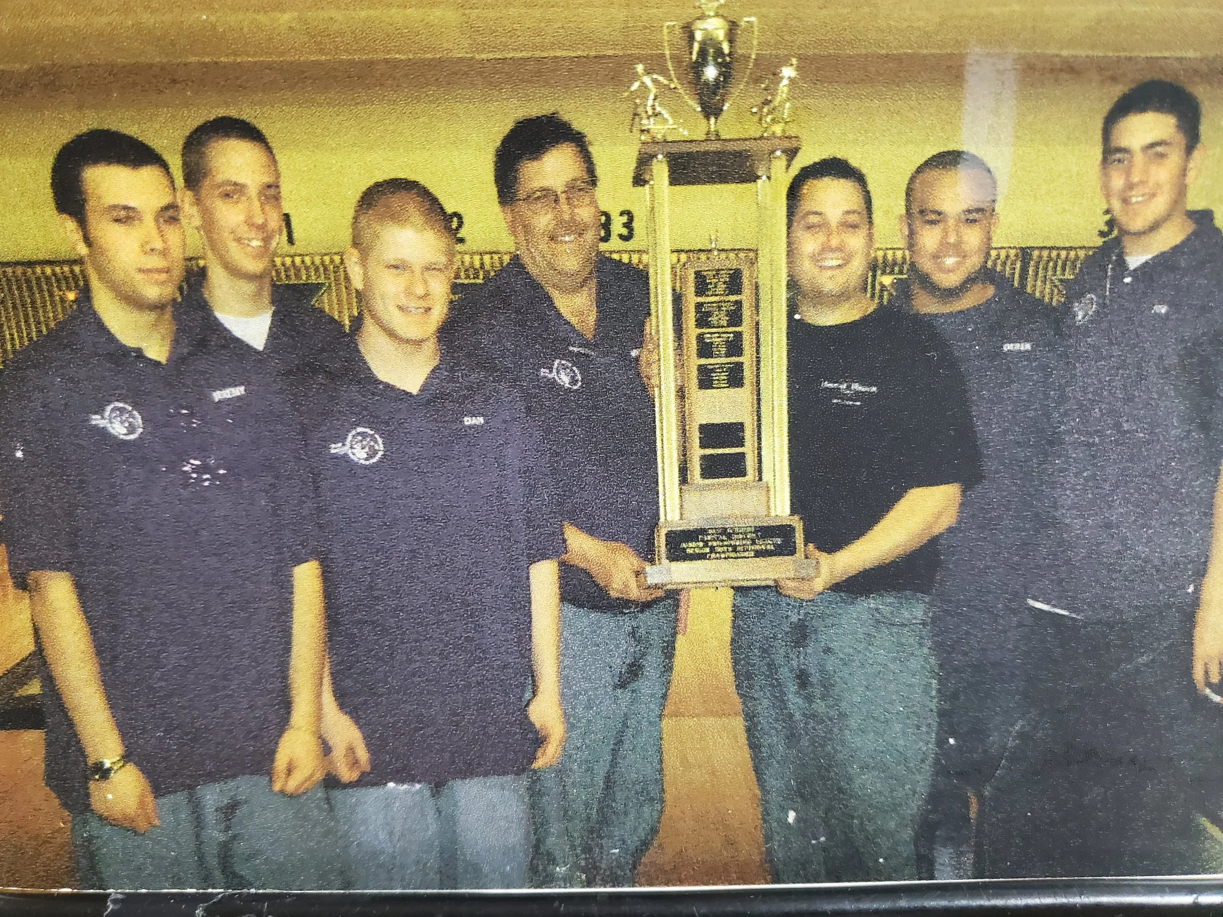 Schenectady bowling team standing with trophy. Photo scanned from newspaper.