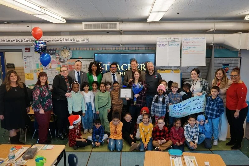 Group photo of Linda Garrigan with key Schenectady administration, SCSDEF President and her classroom.
