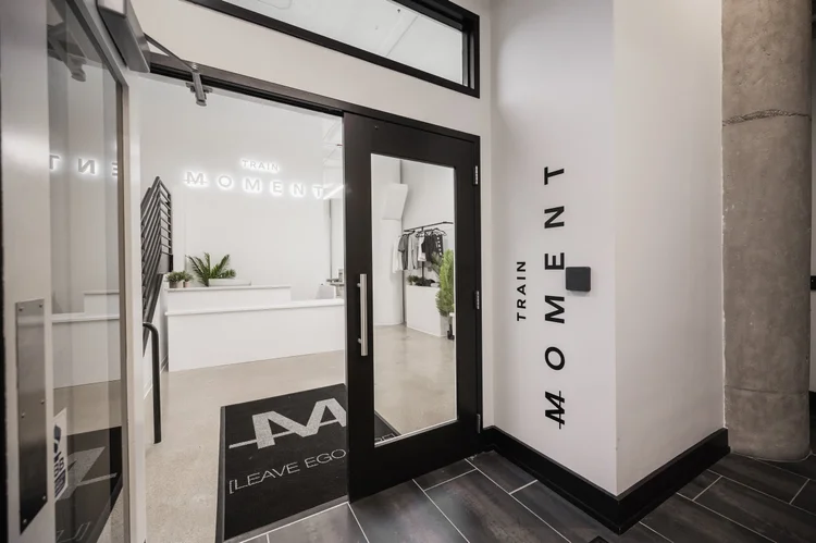 The studio entrance, glass doors carrying the TRAIN Moment wordmark