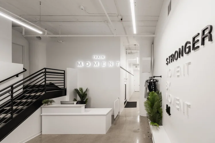 The reception area and stairway, STRONGER lettering on the far wall