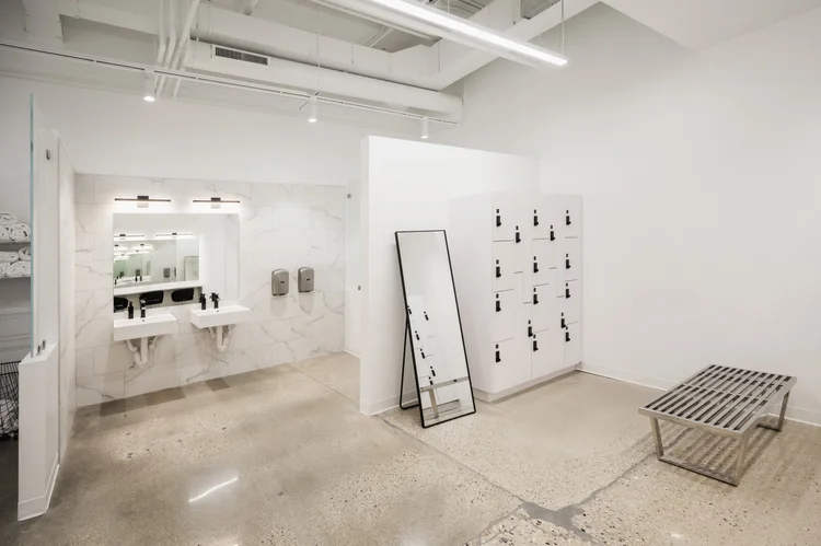 The changing room, with mirrors, sinks and a towel rack