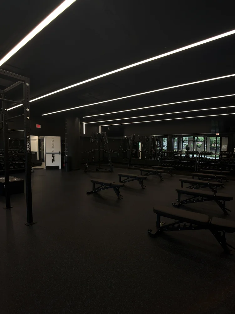 The training floor, benches in rows under linear ceiling lighting