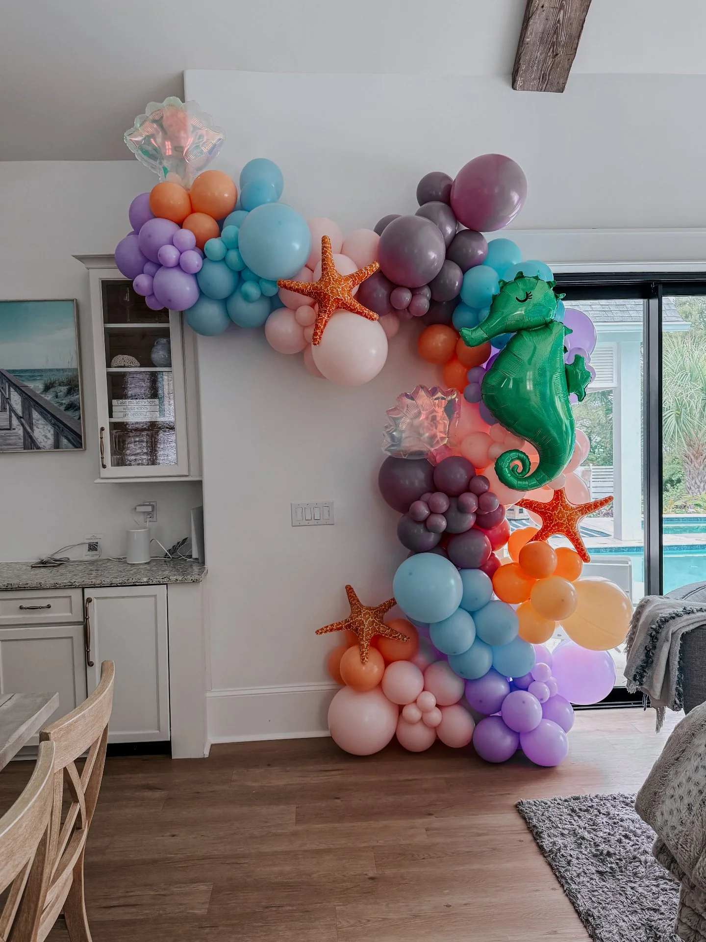 The layered ocean tones, oversized sea creatures, and soft organic textures completely transformed the room into a full experience for the celebration.

Beach house parties deserve more than basic decorations taped to the wall.