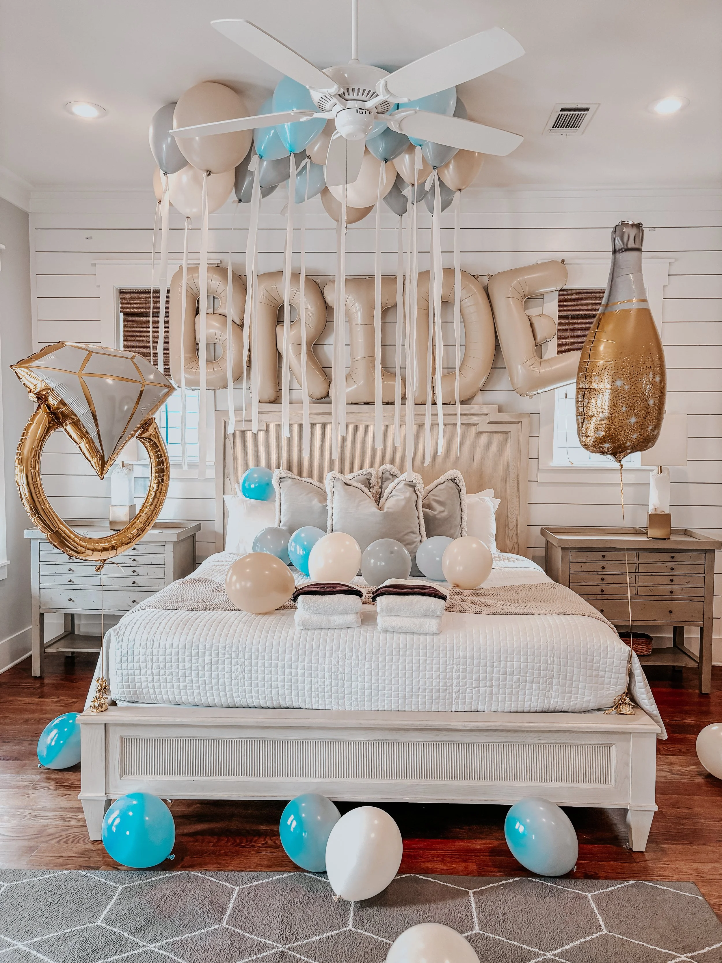 Bridal suite surprise with helium balloons and engagement-themed décor inside a luxury vacation rental in Alys Beach, Florida.