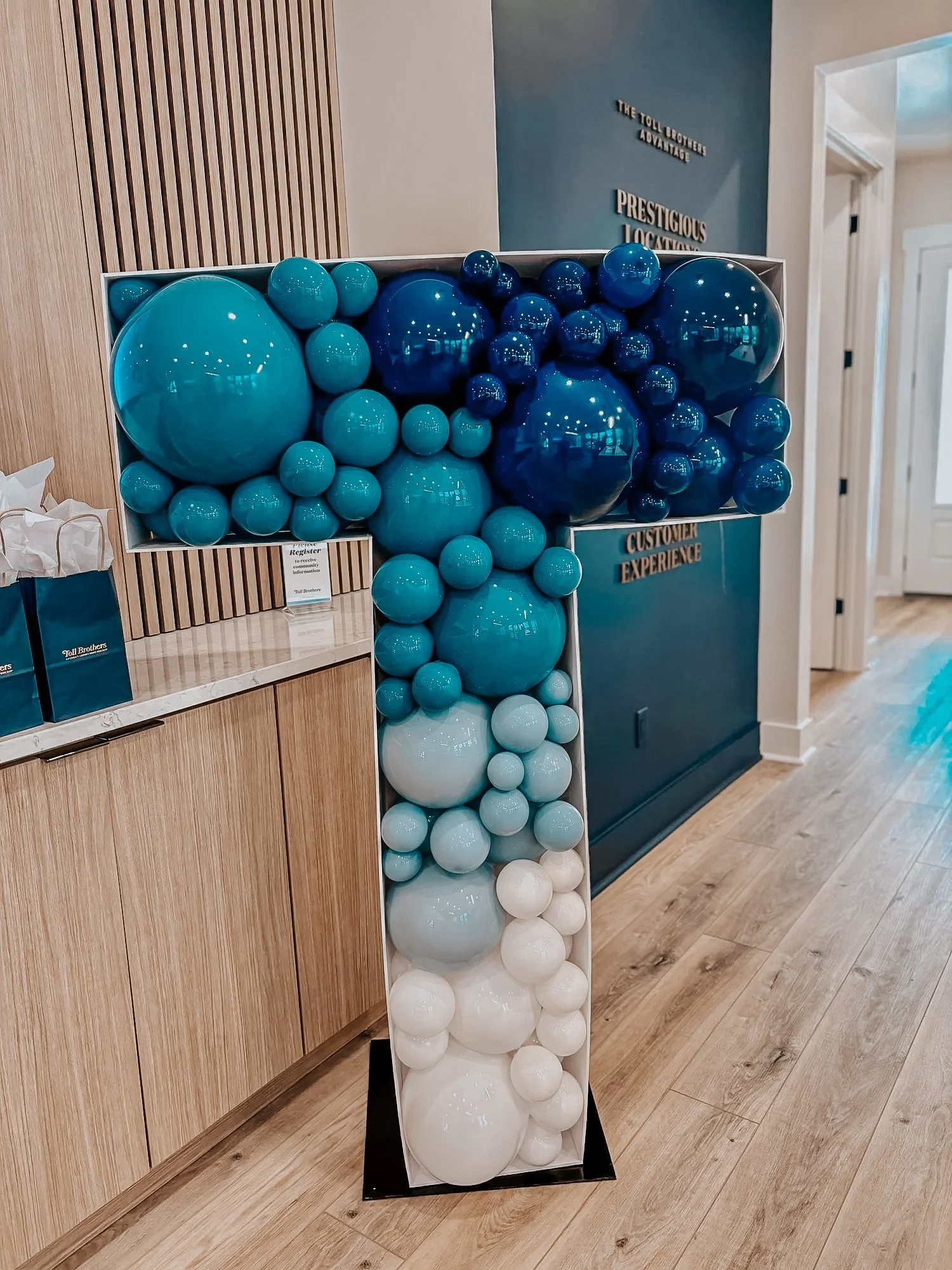 Blue and white balloon number “1” display styled for a 30A first birthday celebration in an indoor event space.