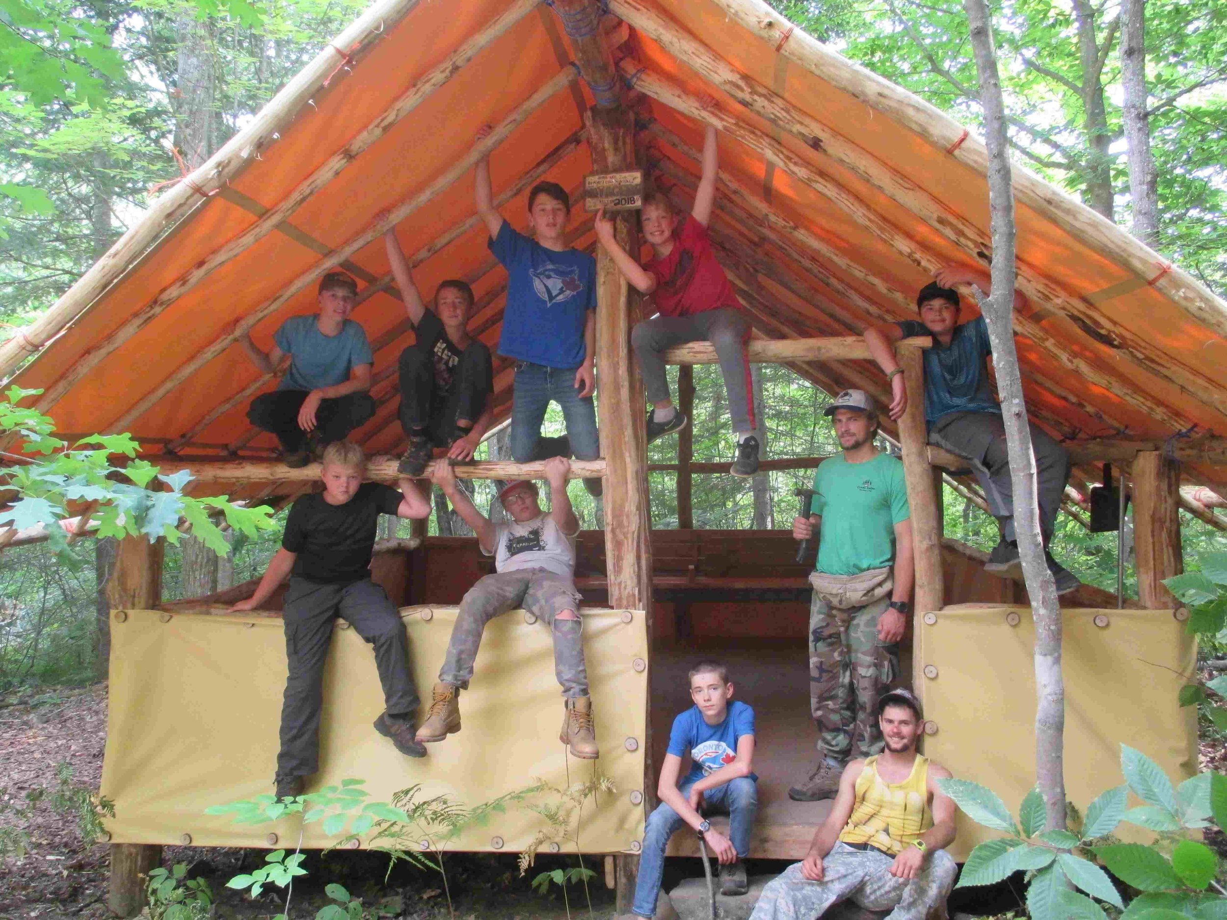 boys are proud of the tent they built.jpg