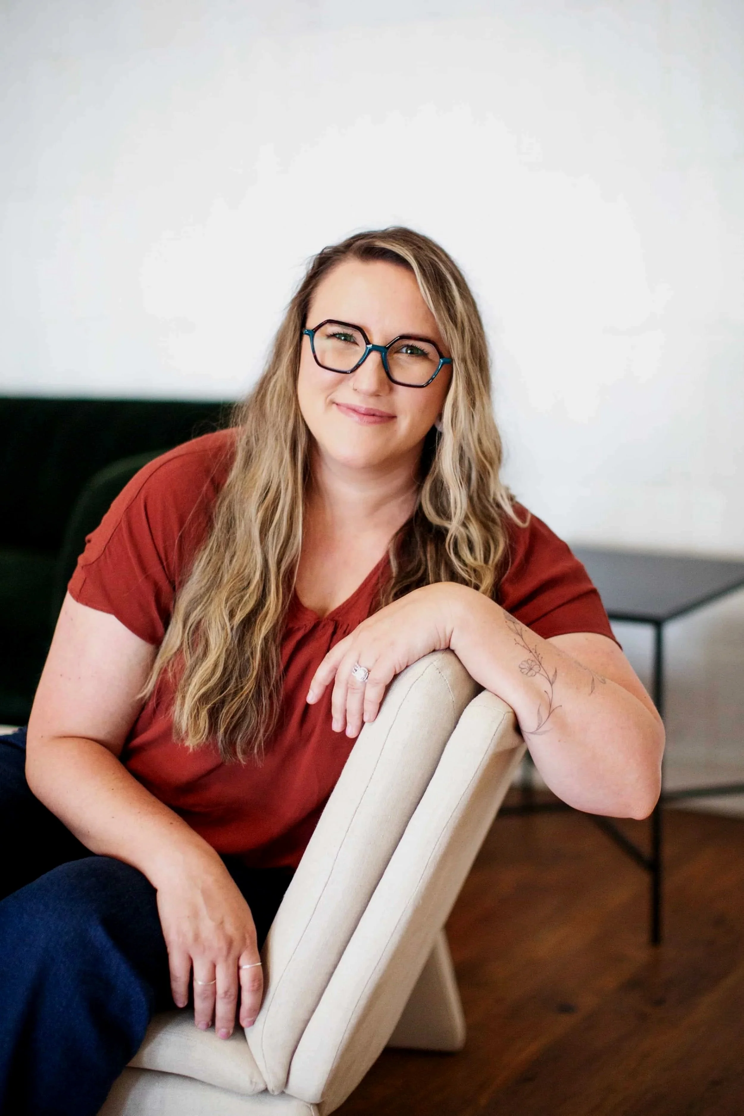Sarah Robinson smiles at the camera, her arms folded one on top of the other