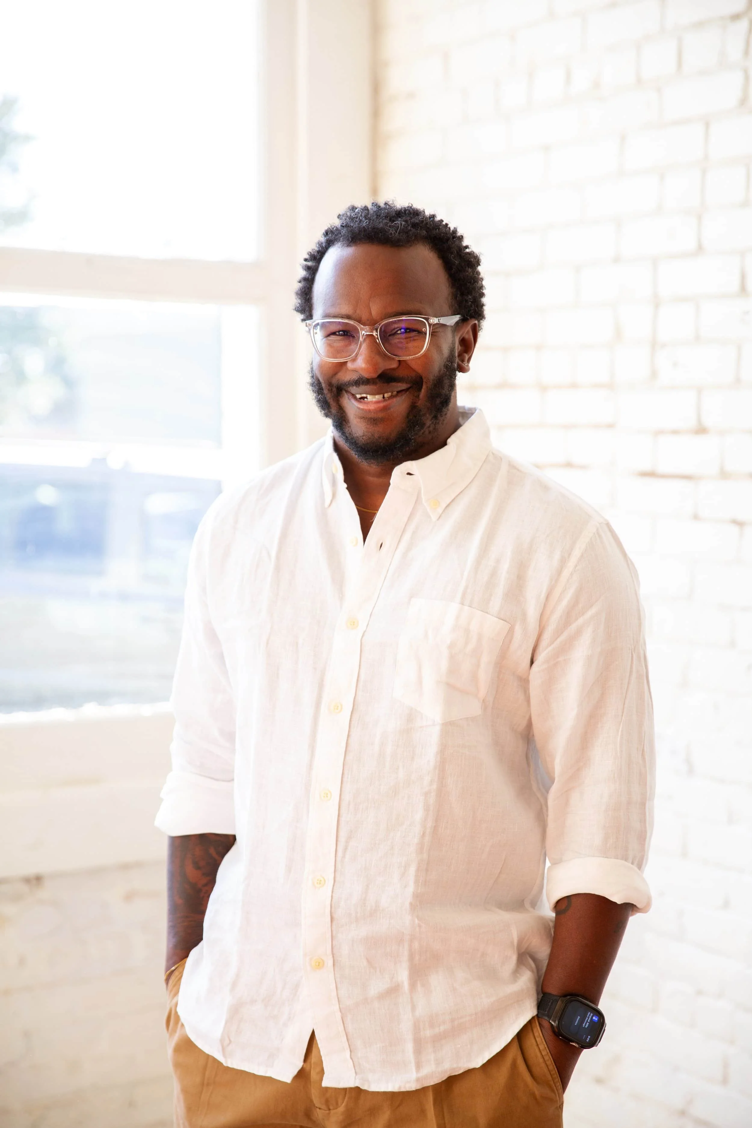 ATXMH therapist and co-owner Damien Robinson smiling enthusiastically to camera in professional headshot