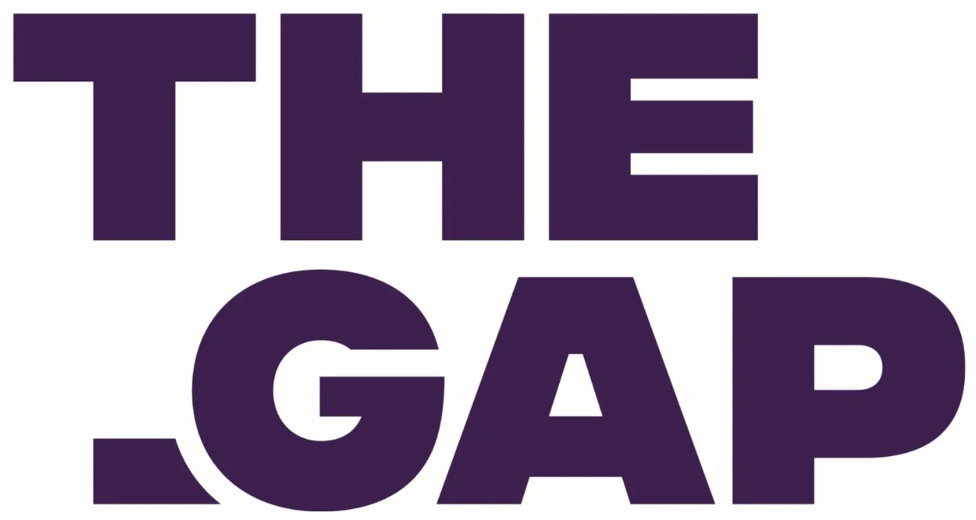 Text that reads 'THE GAP' in large, bold, dark purple letters on a white background.