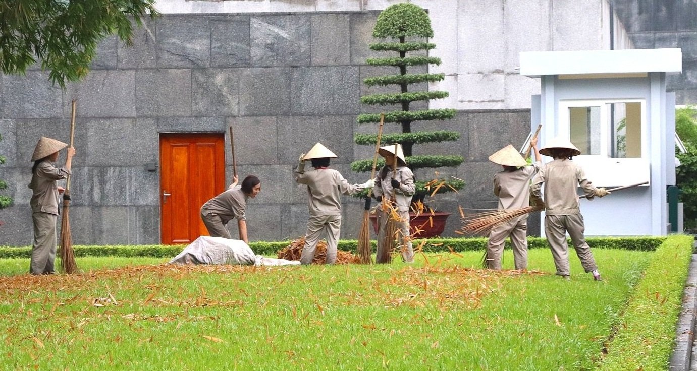 Women raking leaves, Ho Chi Minh's Mausoleum, Hanoi, Vietnam