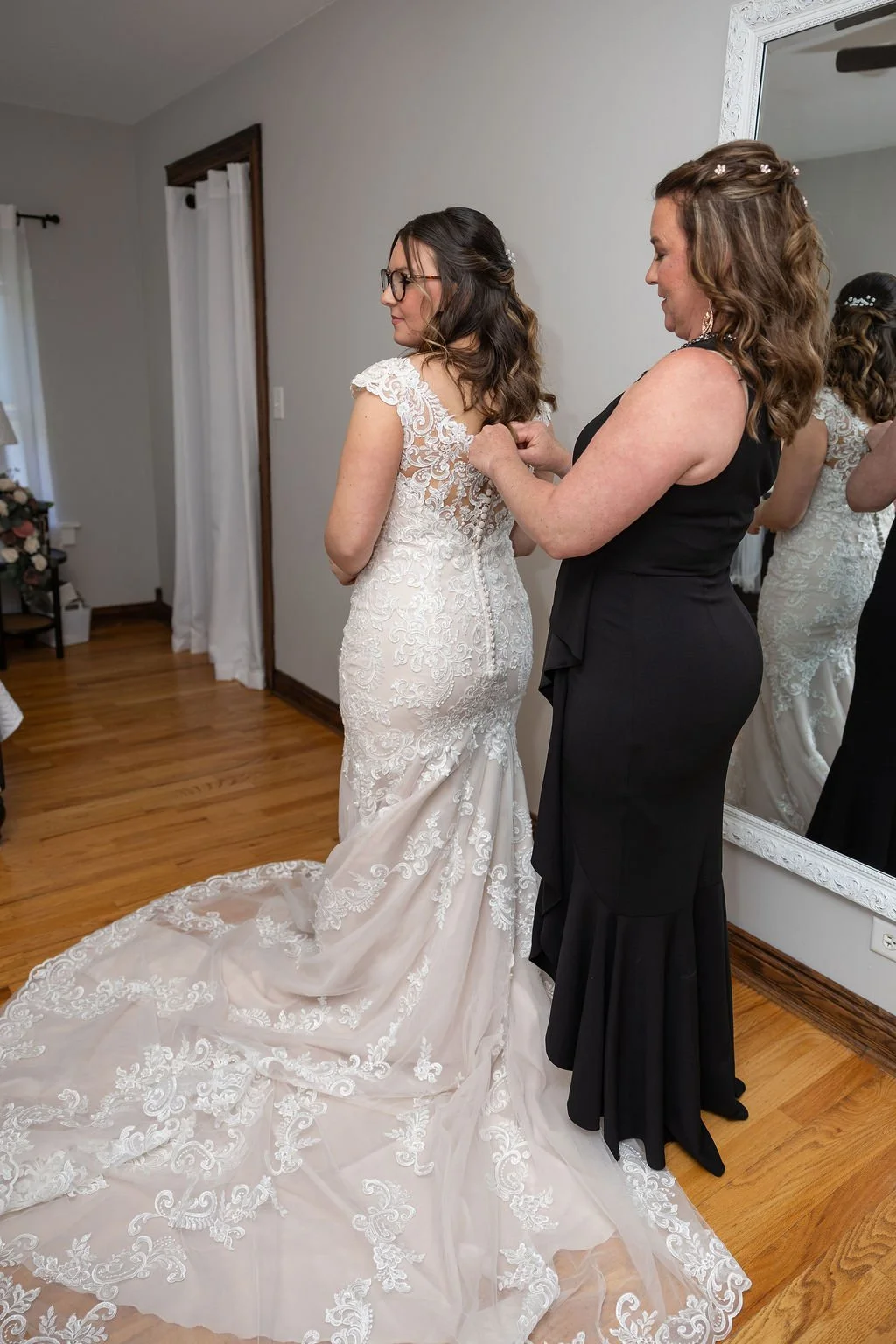 The MOB buttoning the bride's dress in the bride's room at Country Coach House in Burlington, IL. 