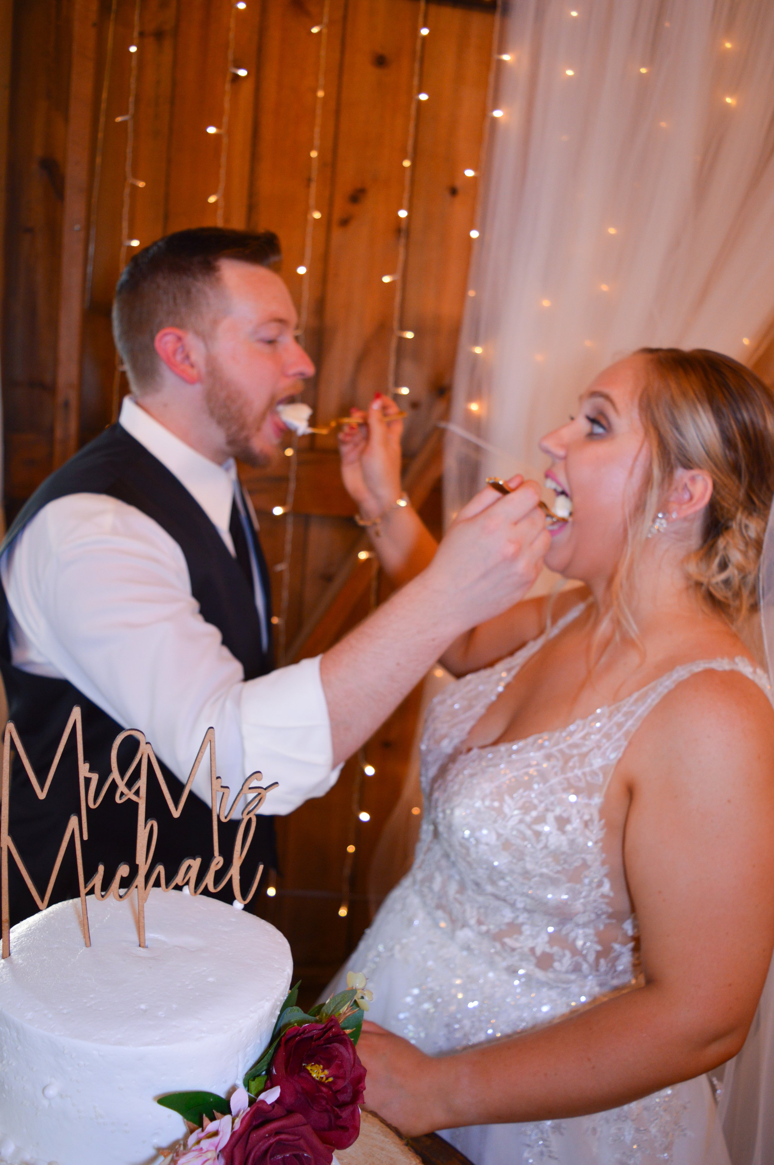 A couple playfully feeding cake to each other. Country Coach House, Burlington, IL.  Latimer Photography