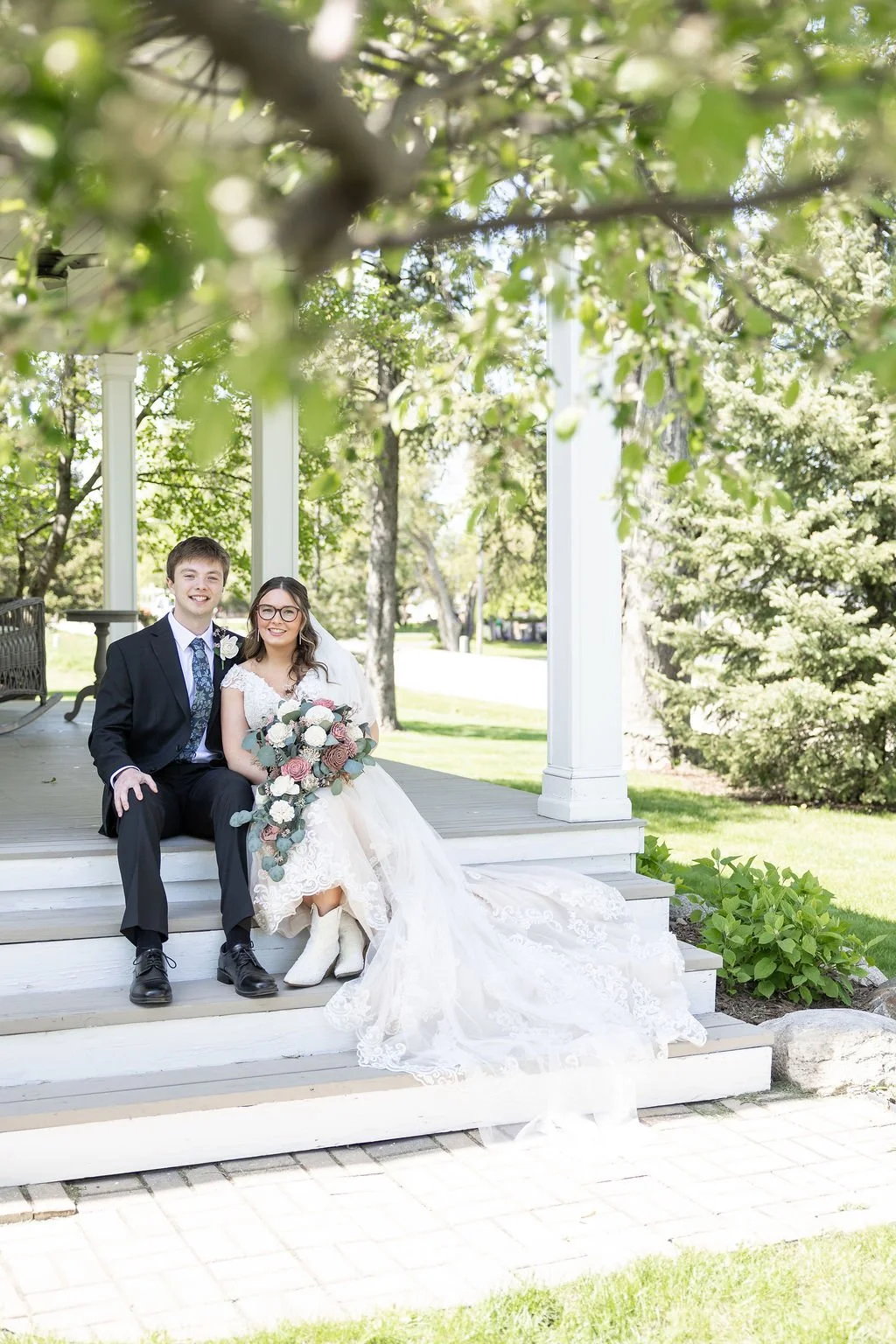 Couple on the front porch of the bridal suite at Country Coach House wedding venue in Burlington, IL 