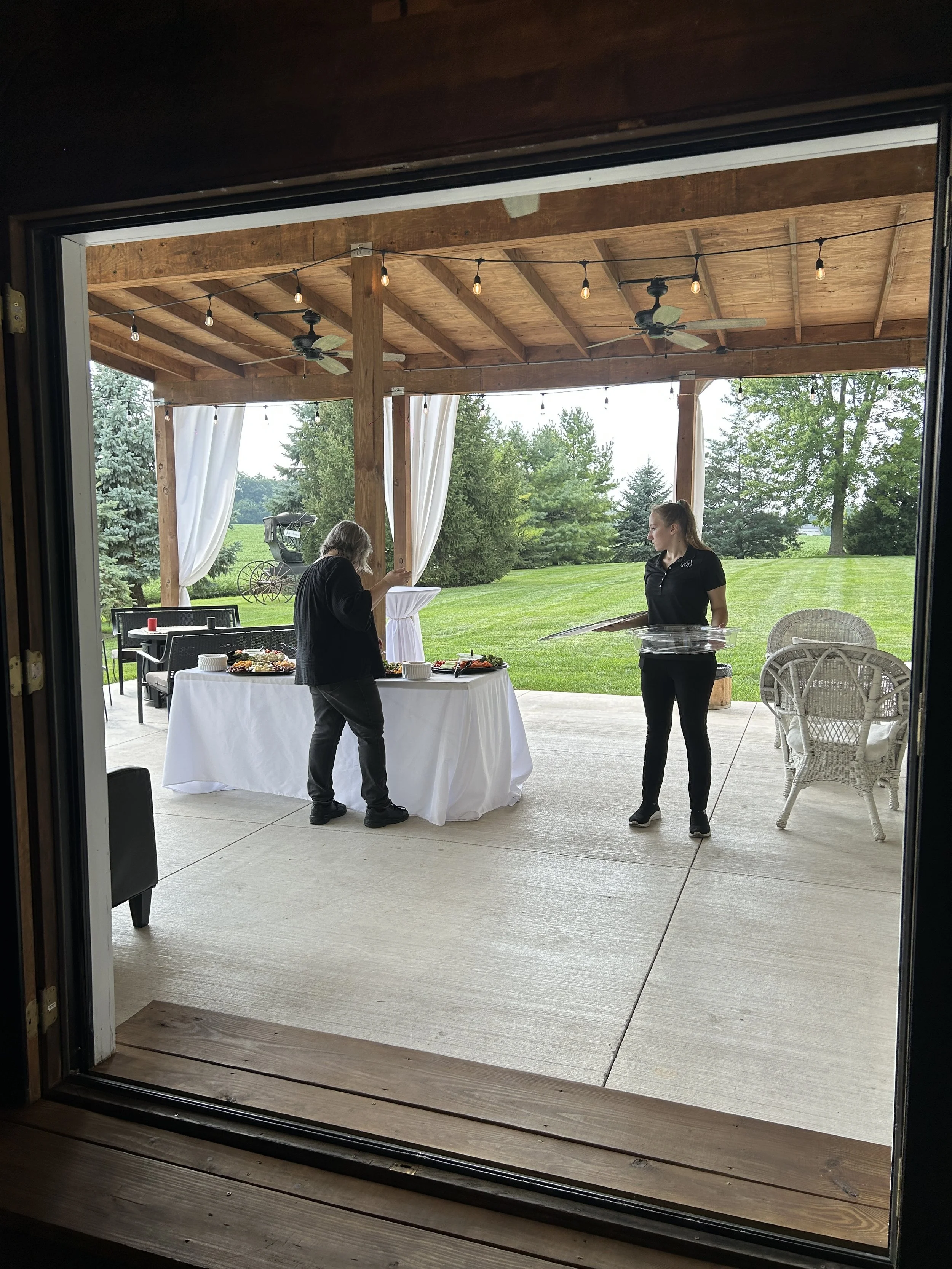 Setting up appetizers on the patio. Country Coach House Photo