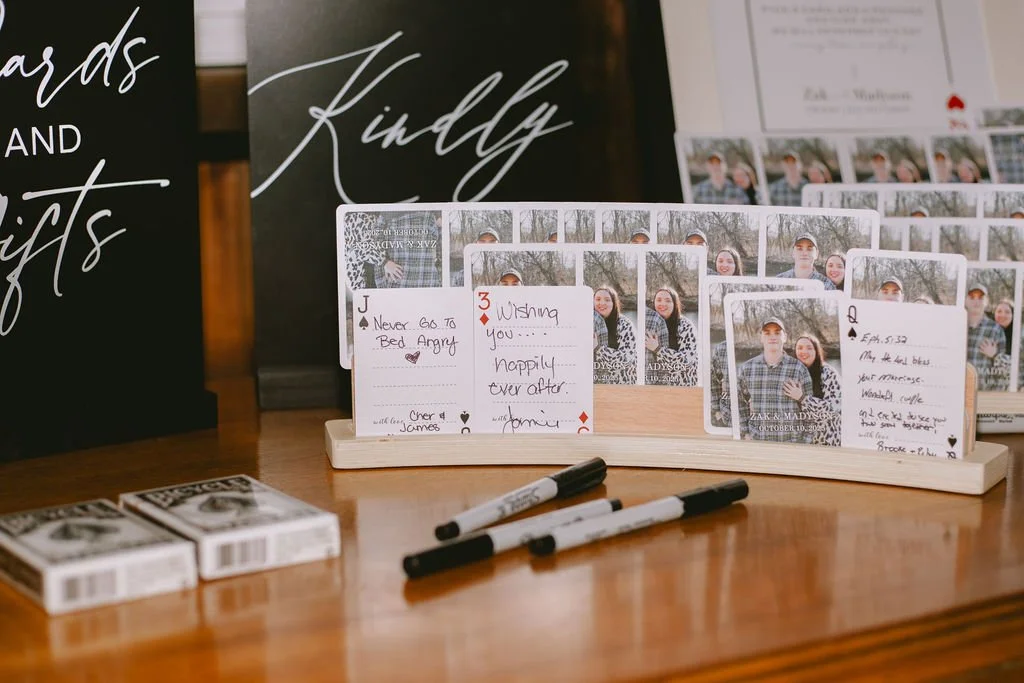 Unique wedding guest book idea with playing cards and engagement photos at Country Coach House wedding venue in Burlington, IL.