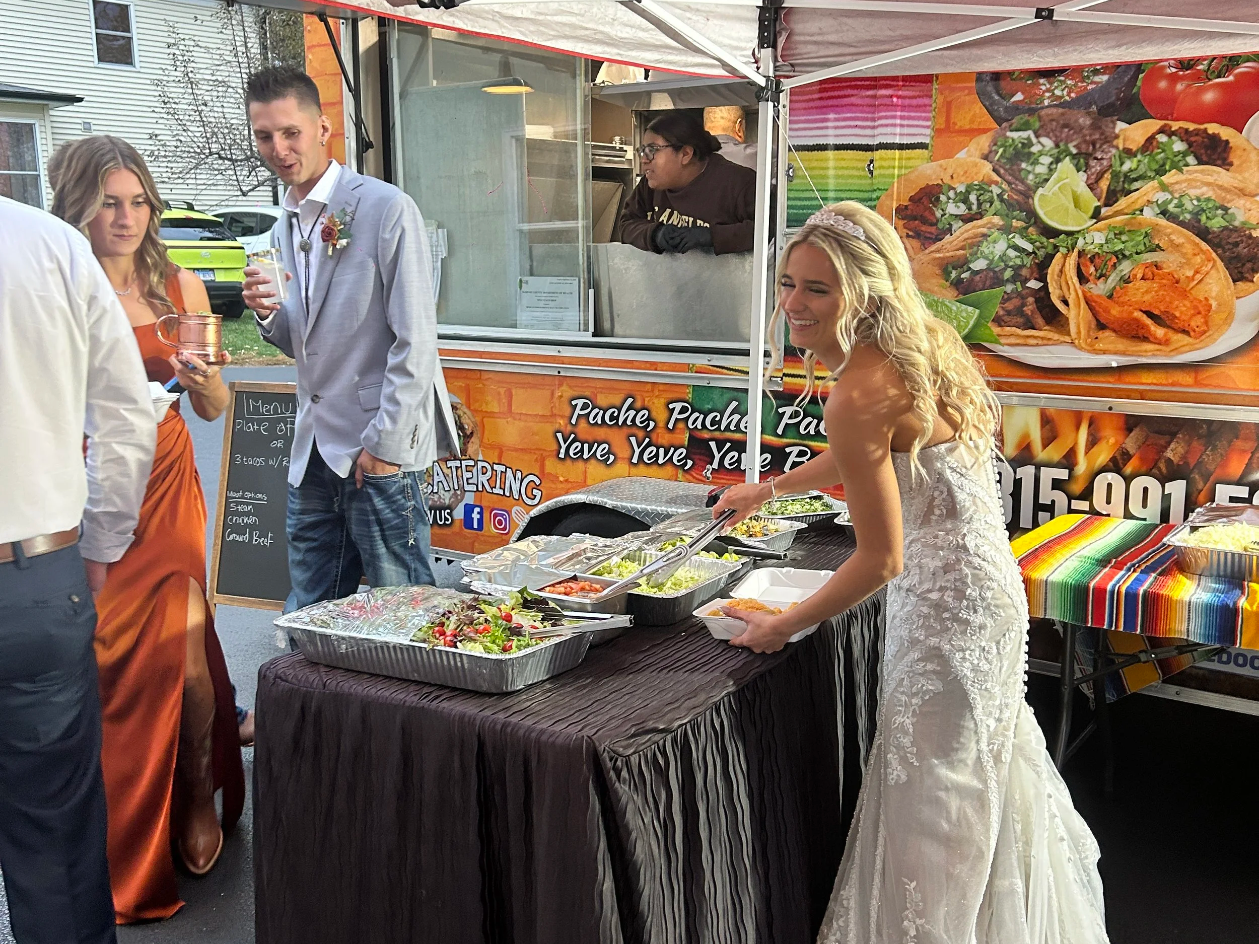 The bride getting her food at the taco truck buffet she chose for her caterer at Country Coach House, in Illinois