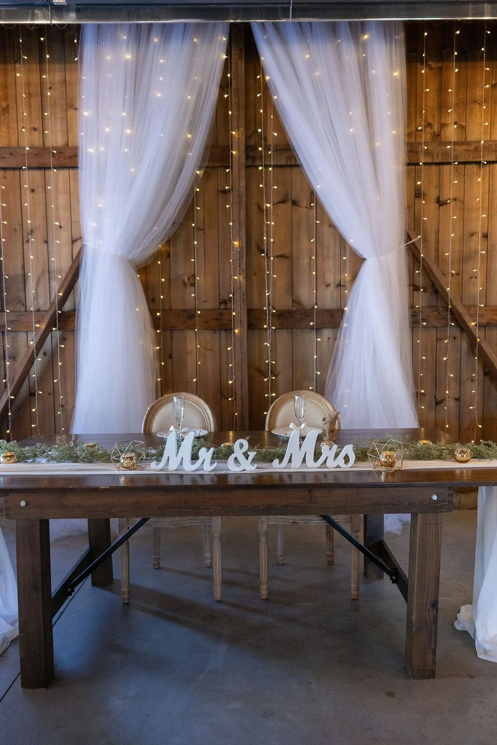 A wood farm table, sweetheart table for the bride and groom at Country Coach House in Burlington, IL.