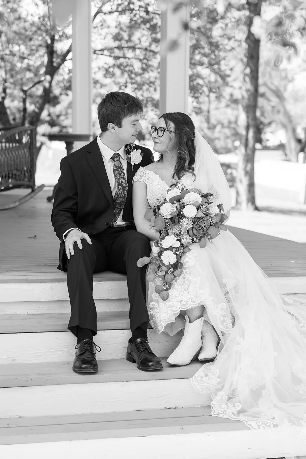 Couple on the front porch of the bridal suite at Country Coach House wedding venue in Burlington, IL 