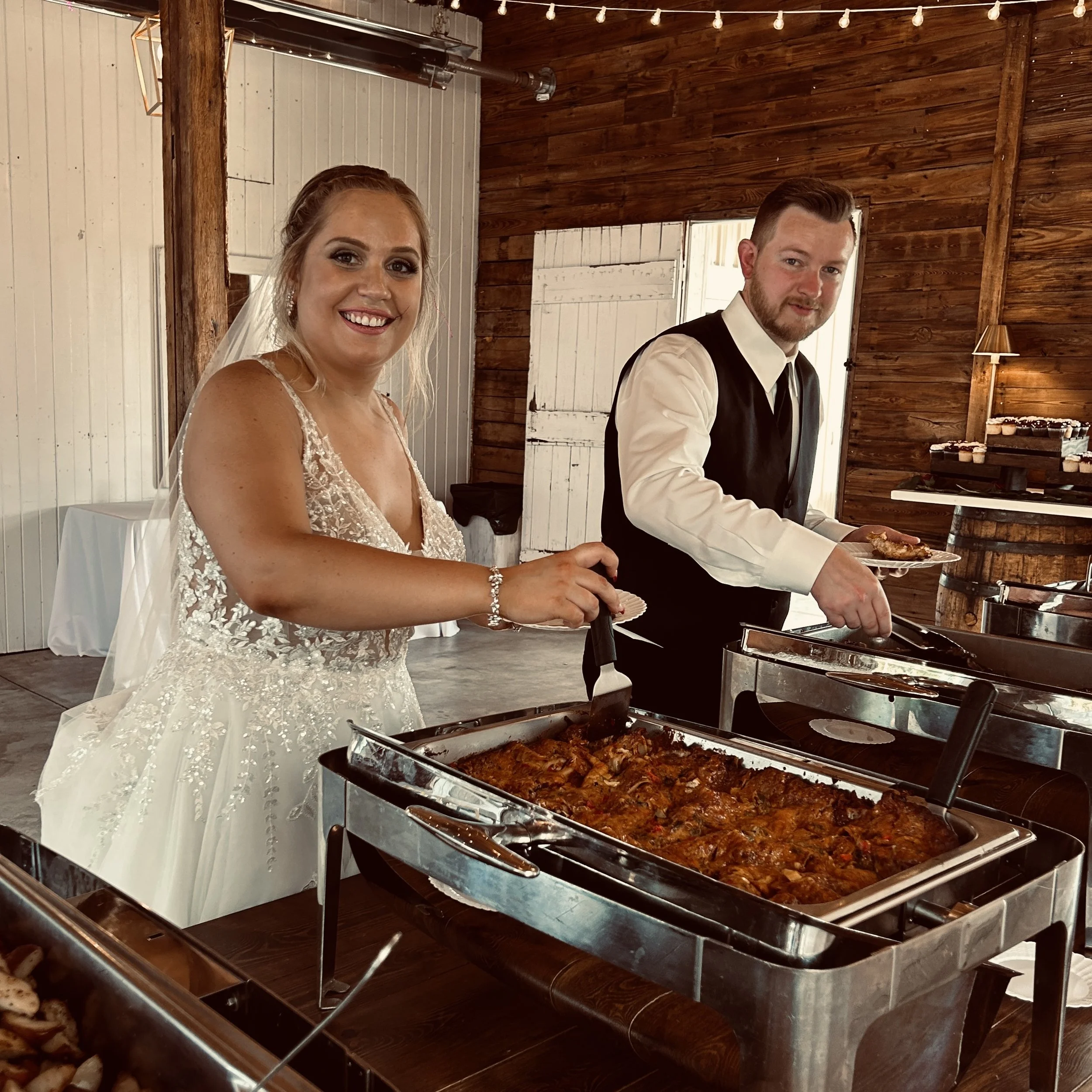 The brida and groom at the buffet provided by HyVee. Country Coach House Photo