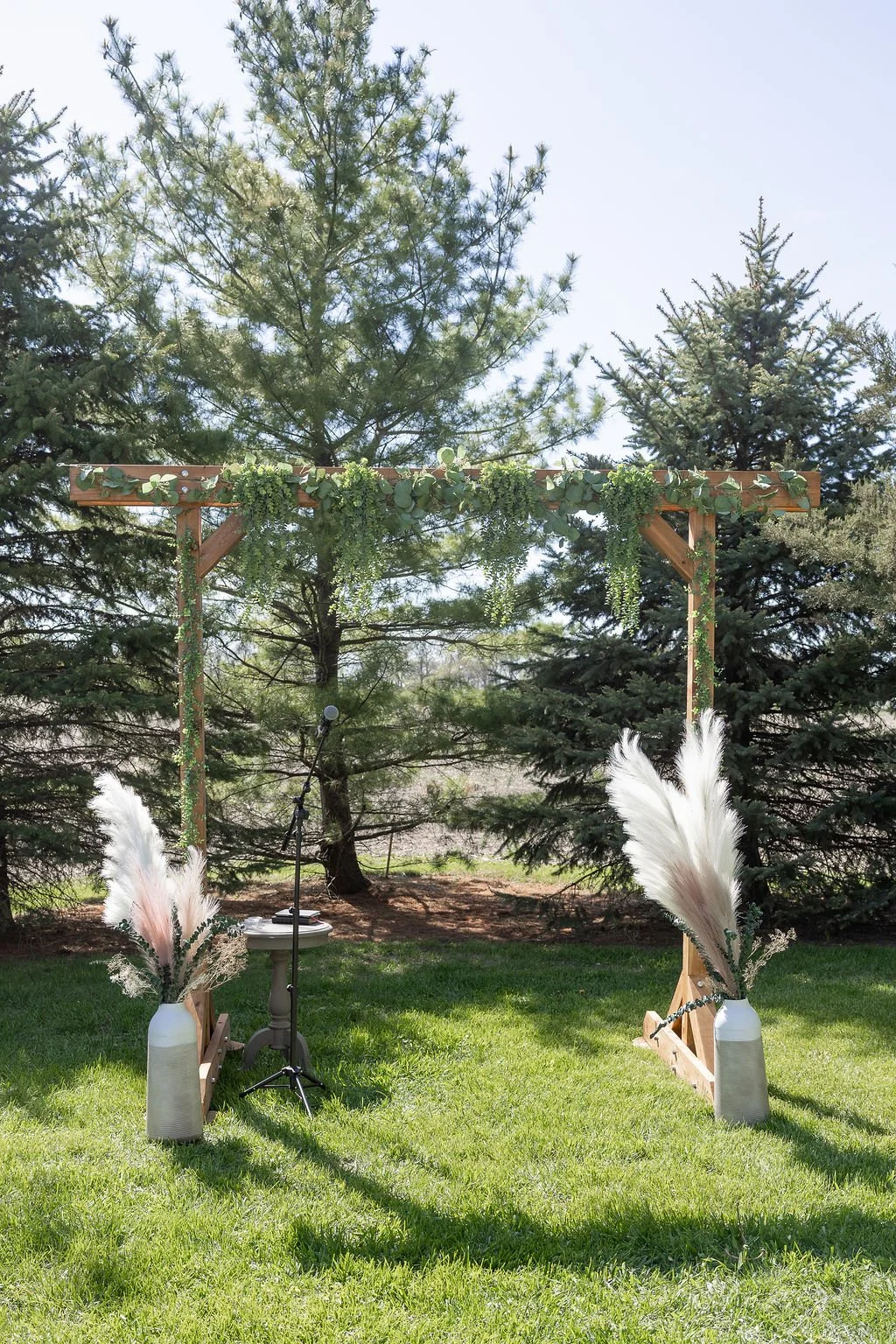 The cedar wedding arbor decorated by the bride at Country Coach House wedding venue in Burlington, IL 