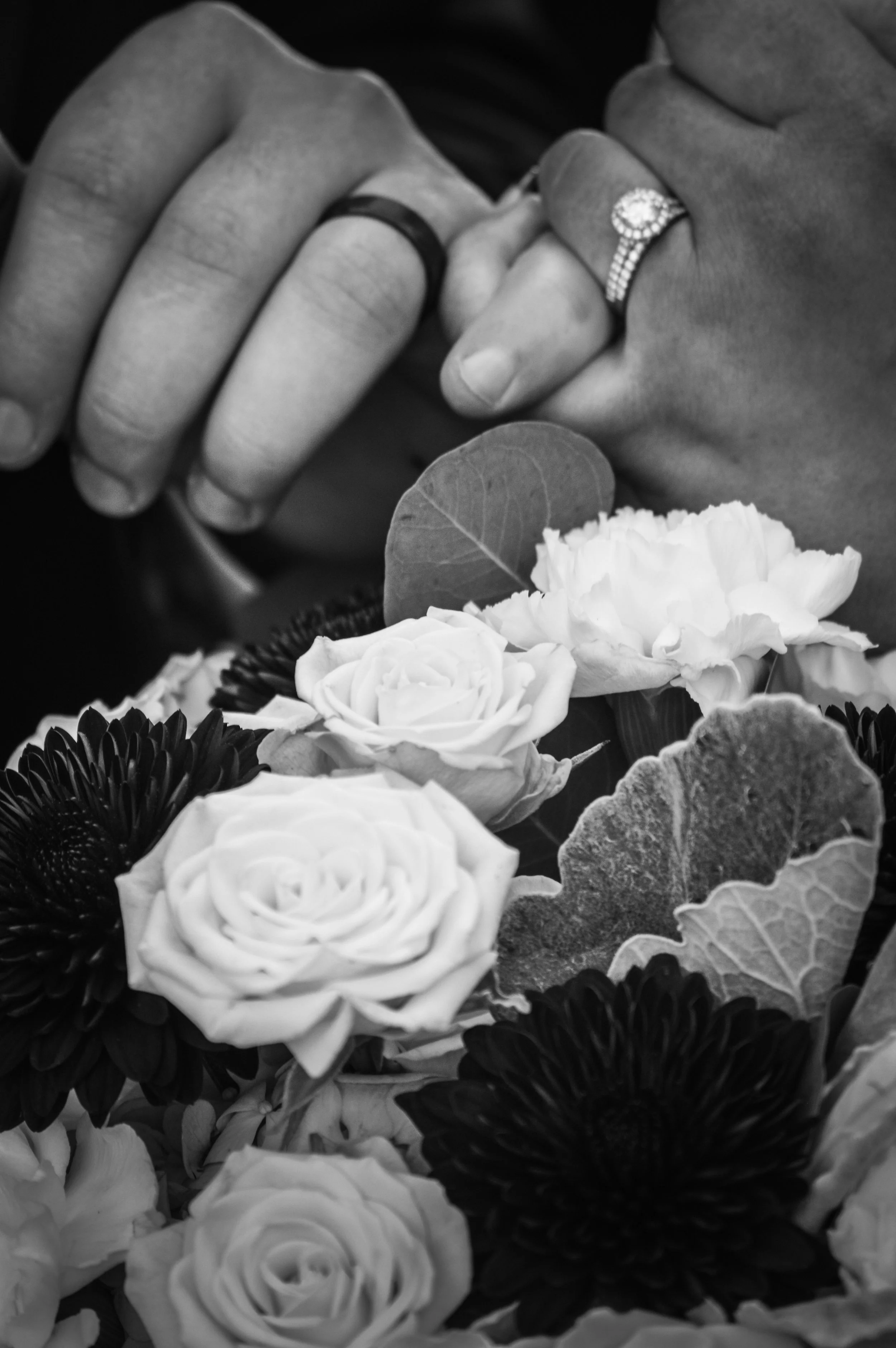 B & W photo of the couple's hands and her bouquet. Country Coach House. Burlington, IL.  Ryan Latimer Photography
