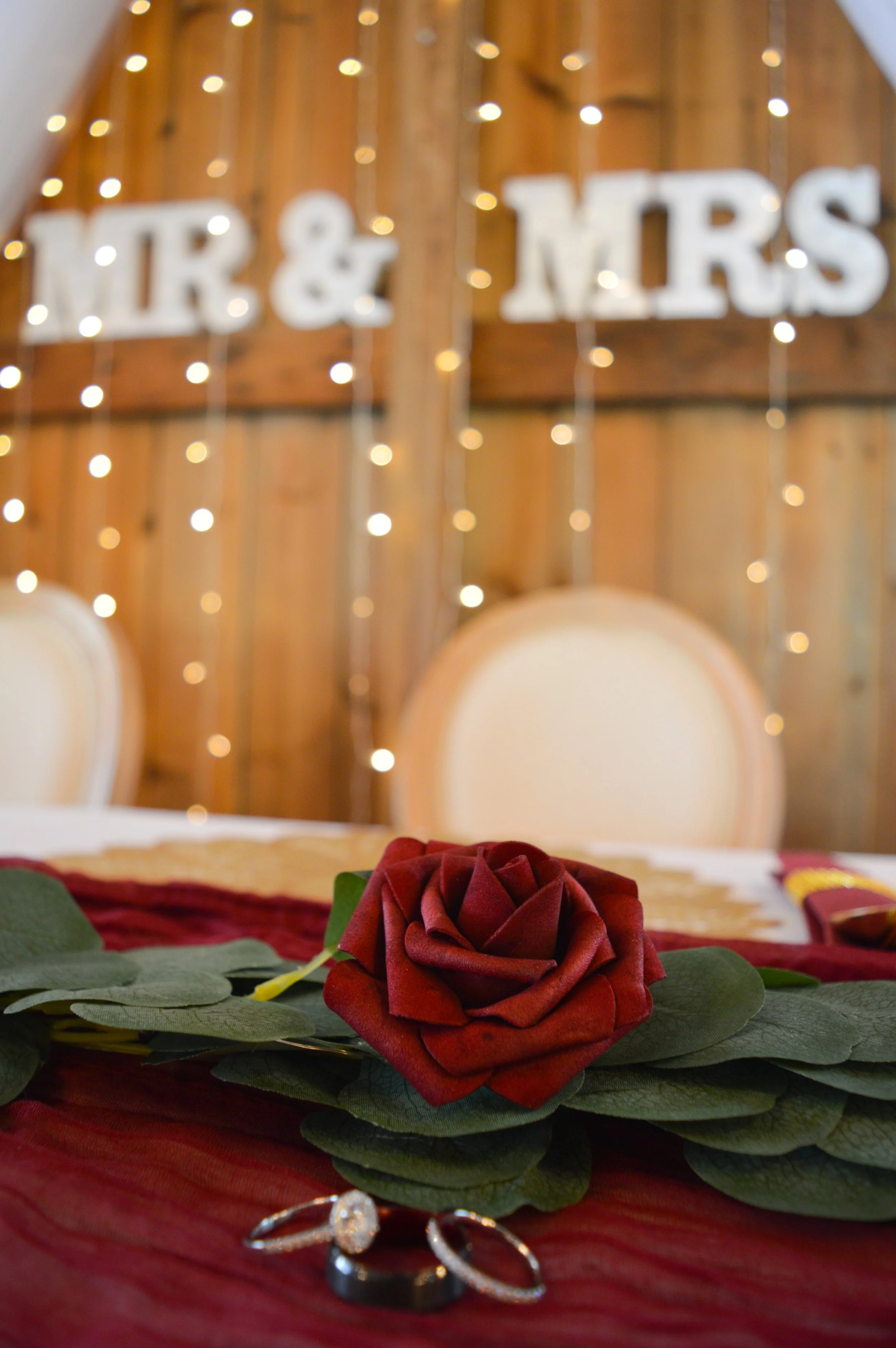 A photo of the wedding rings on the head table at Country Coach House, Burlington, IL.  Ryan Latimer Photography