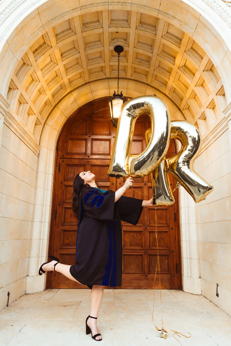 Rollins College graduate celebrating during graduation portrait session
