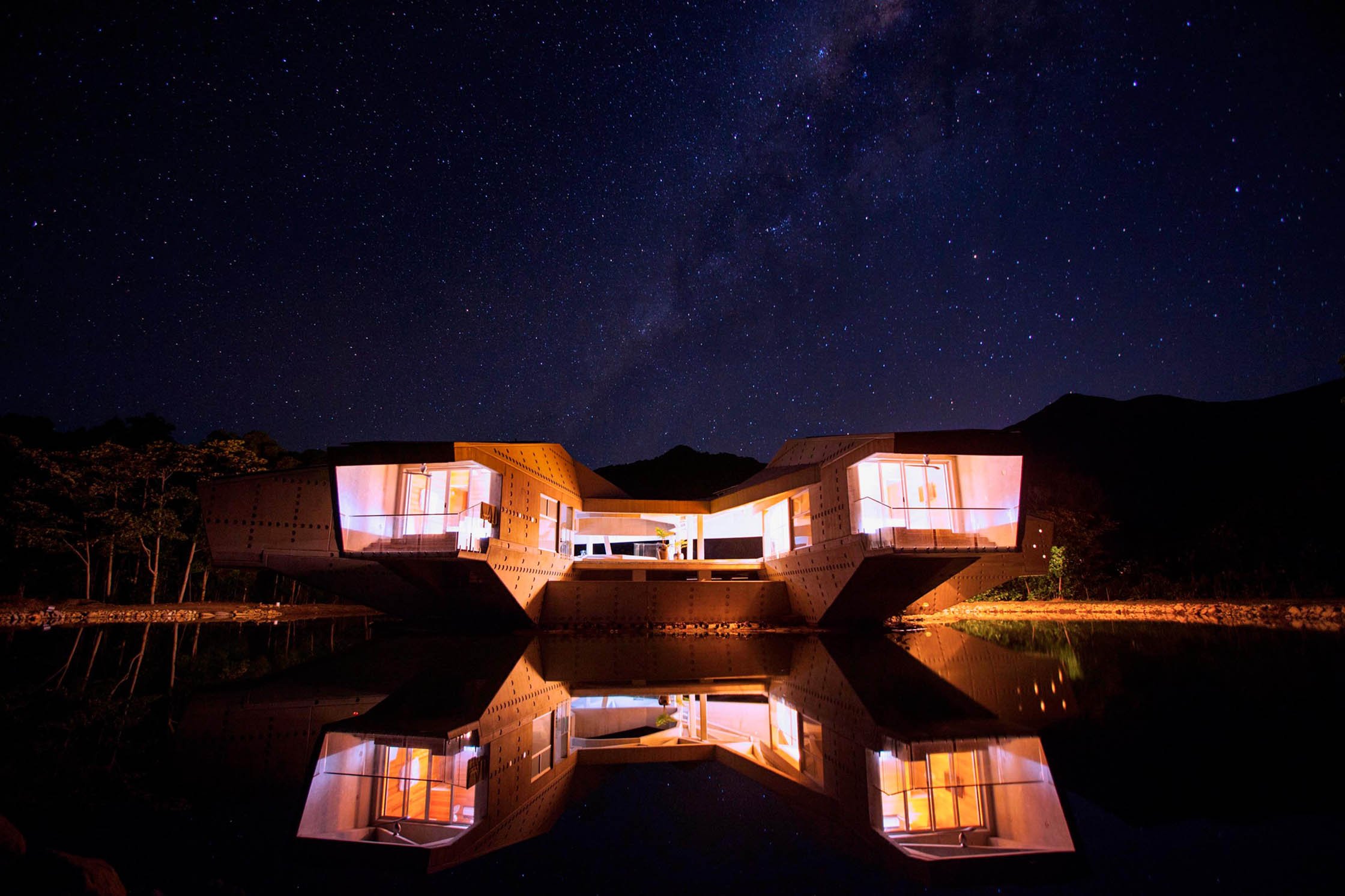 Alkira Resort House lit up at night, away from the pollution of the city with millions of stars in view