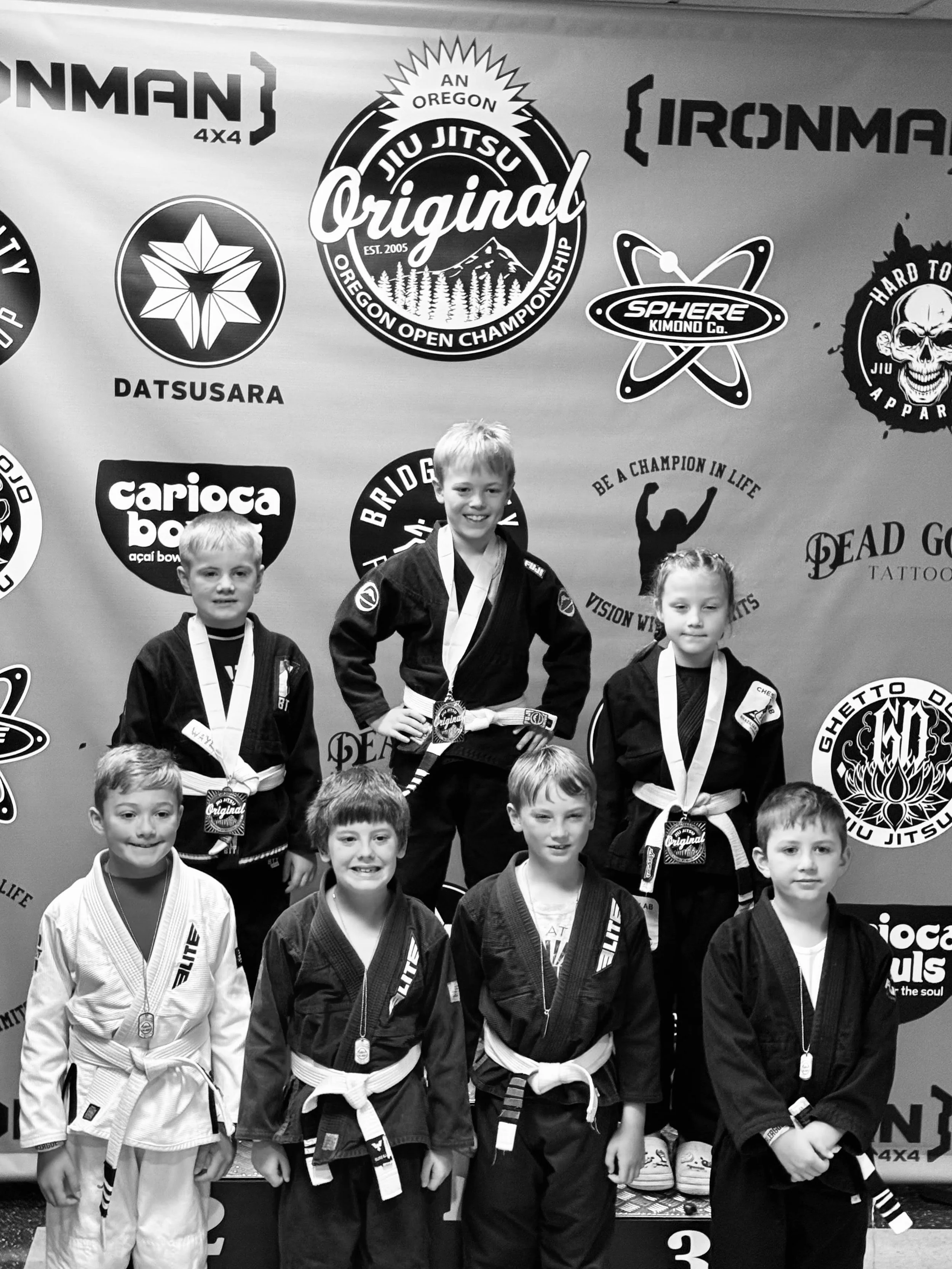 Kids jiu jitsu team competitor atop podium after placing first at the 2025 Oregon Open in Tualatin, OR