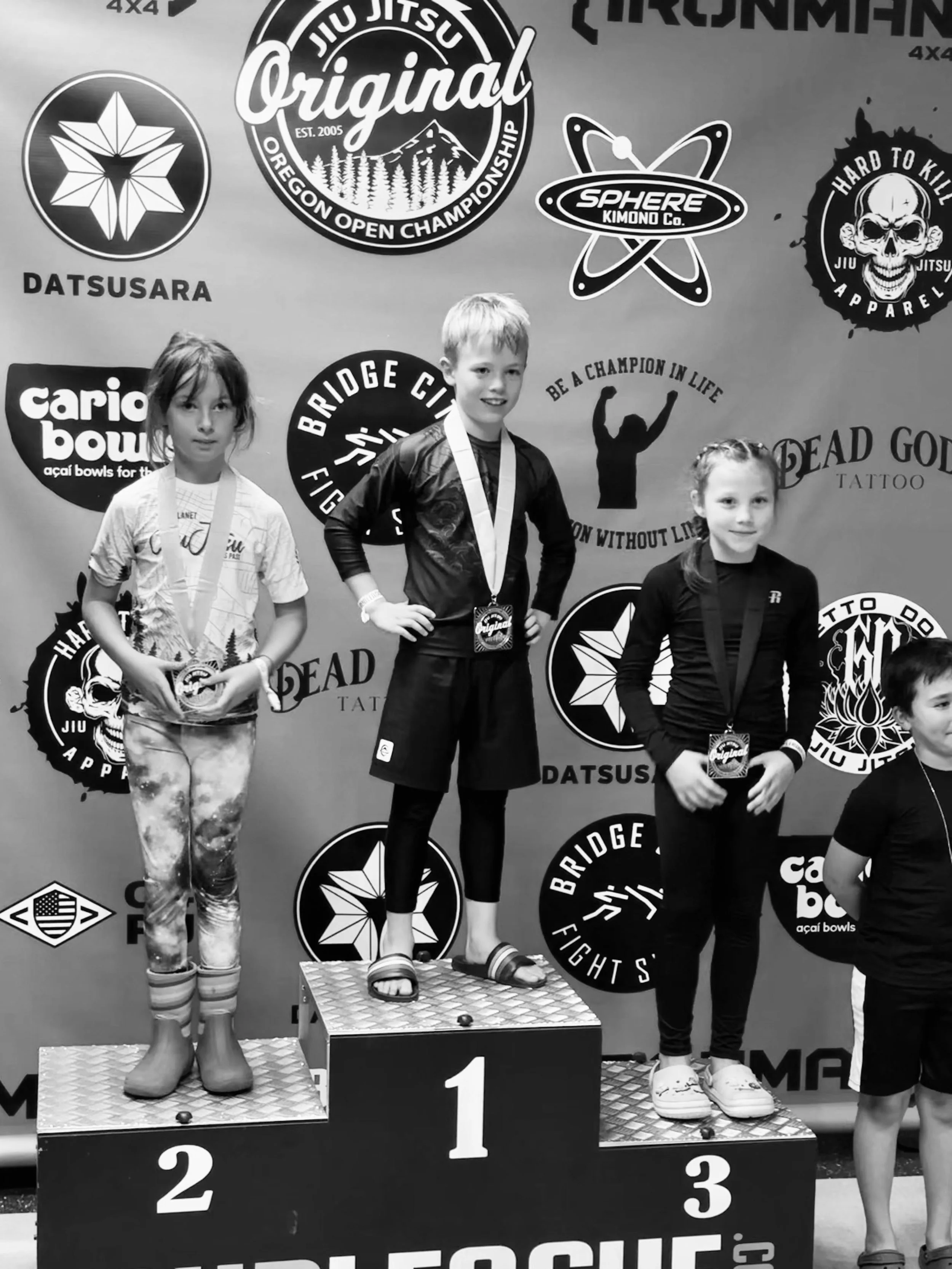 kids nogi BJJ competitor with first place medal on podium at Oregon Open tournament in Tualatin