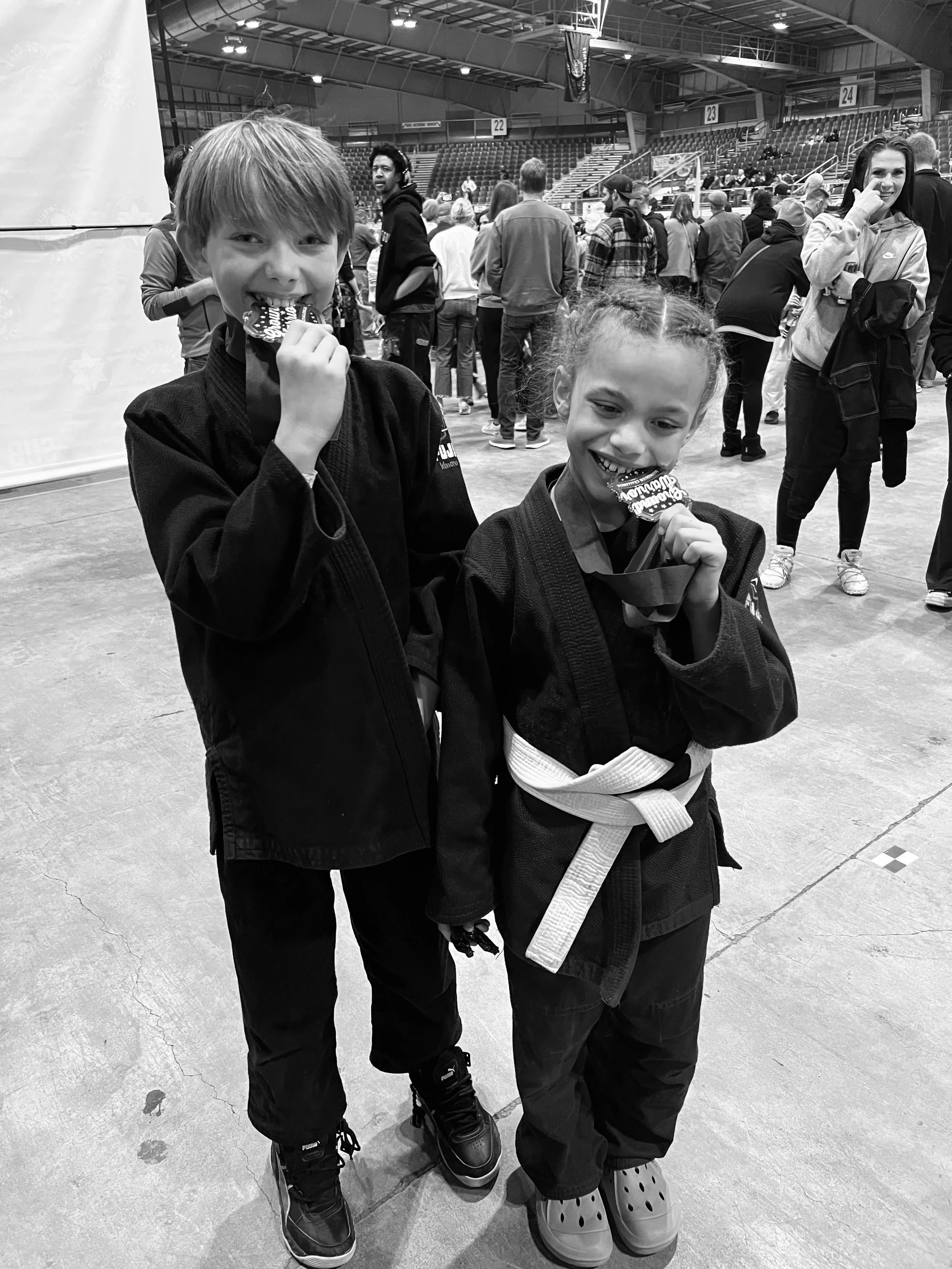 Kids jiu jitsu team competitors showing off their gold medals