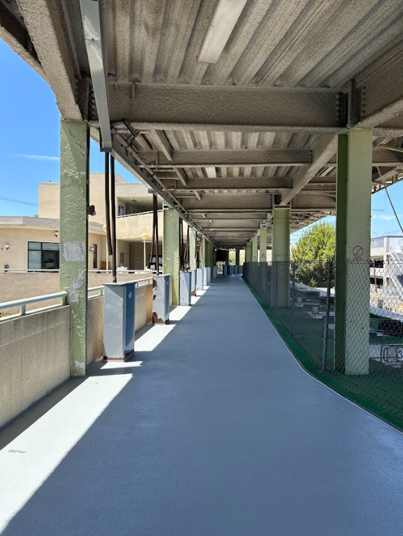 Covered walkway deck with a finished waterproof coating
