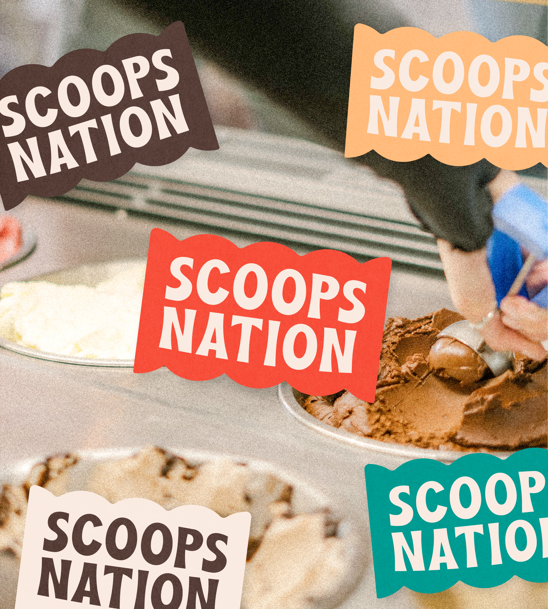 Multiple colorful Scoops Nation flags placed on various ice cream dishes.