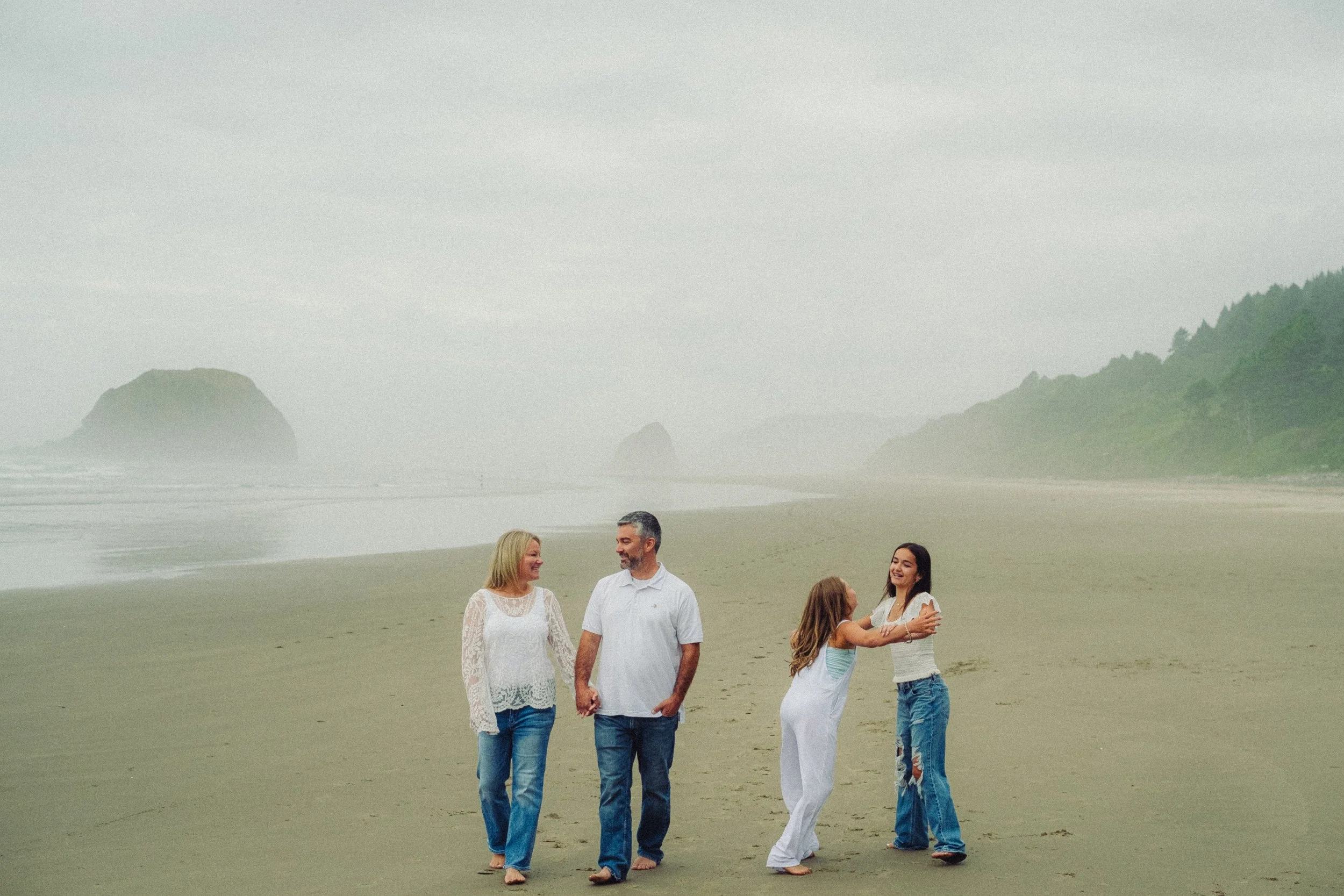 family on cannon beach candidly enjoying the oregon coast