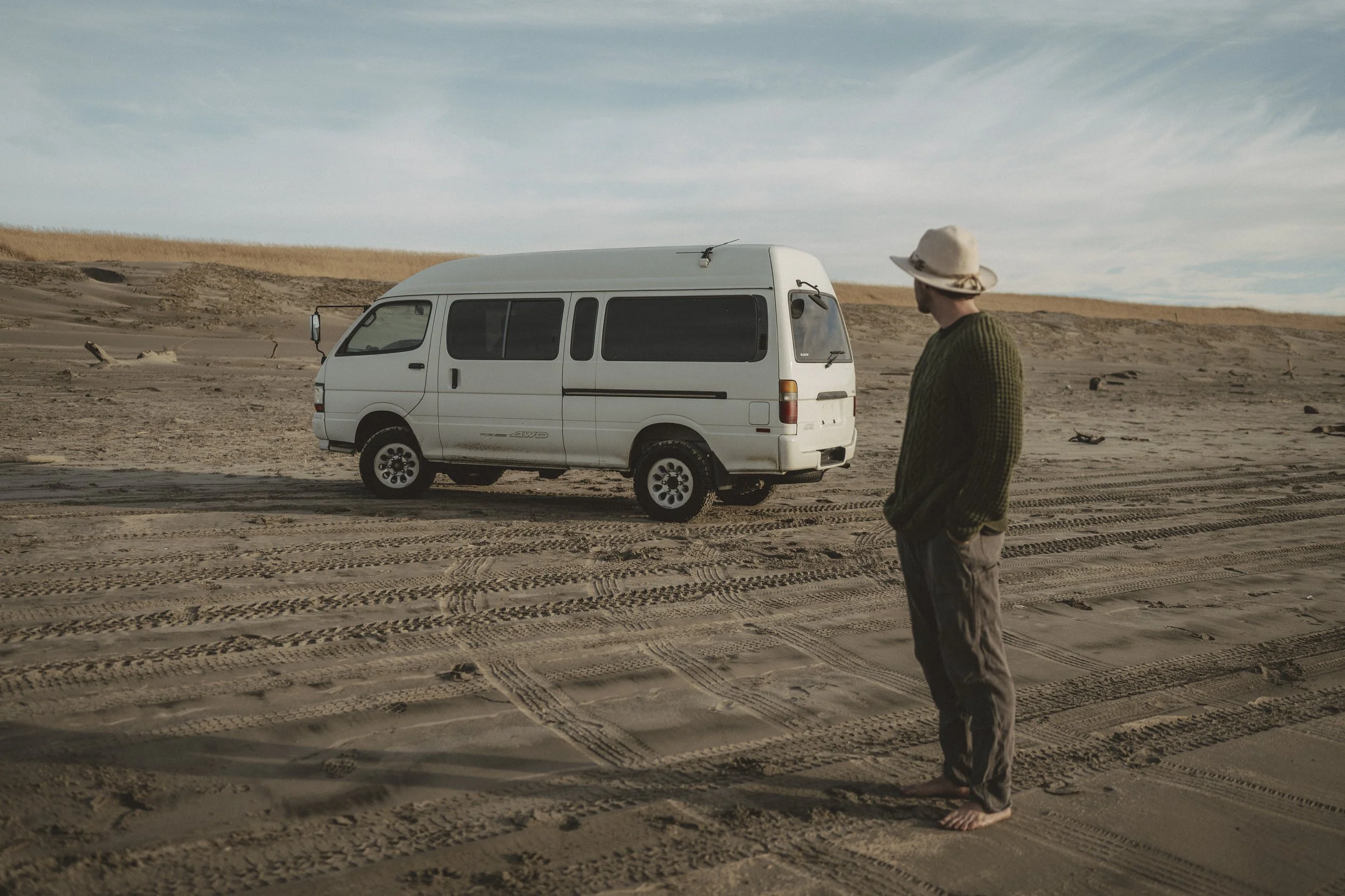 A Photographer ready for adventure on the coast with his van.
