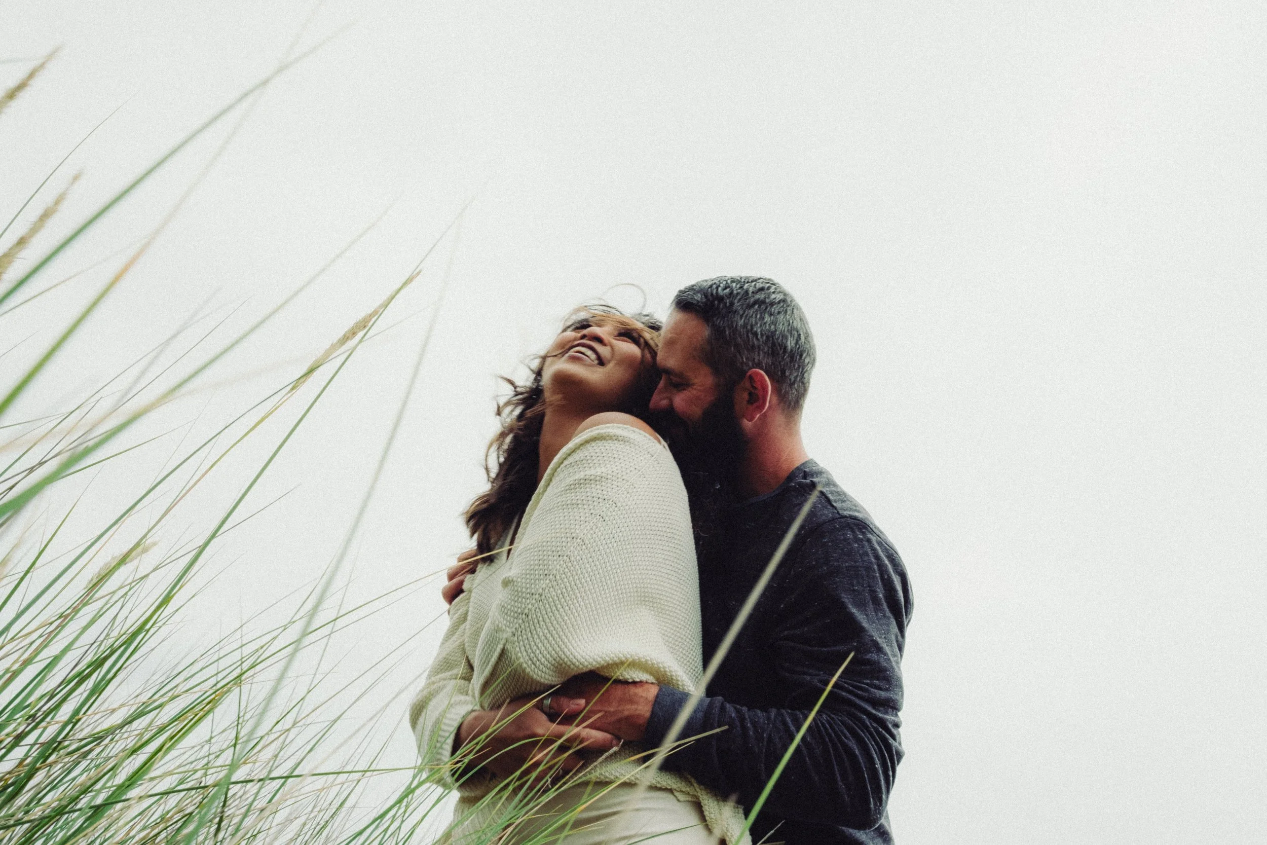 candid cinematic image of couple in love in cannon beach