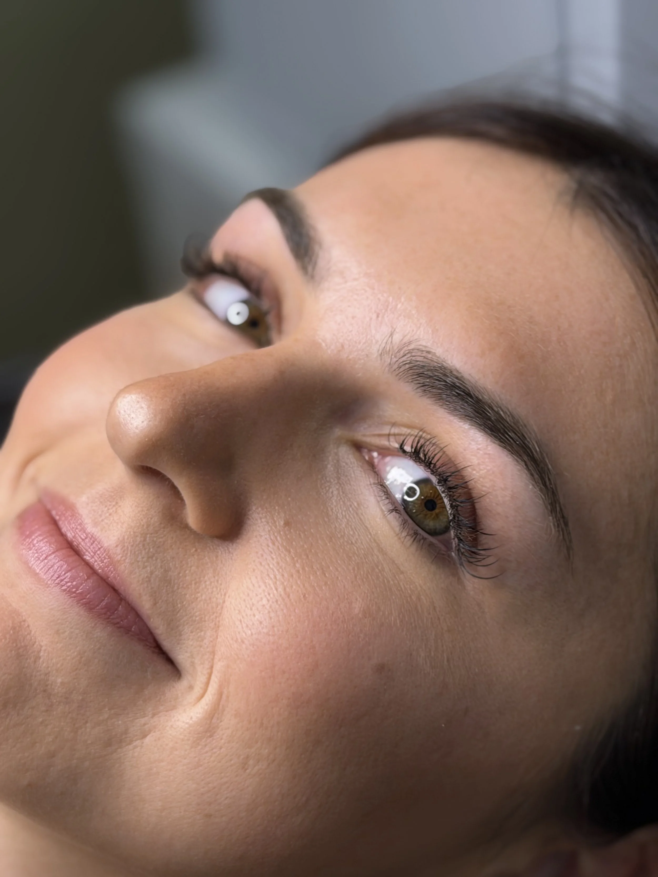 Model looking with lash extensions in for a fuller lash look