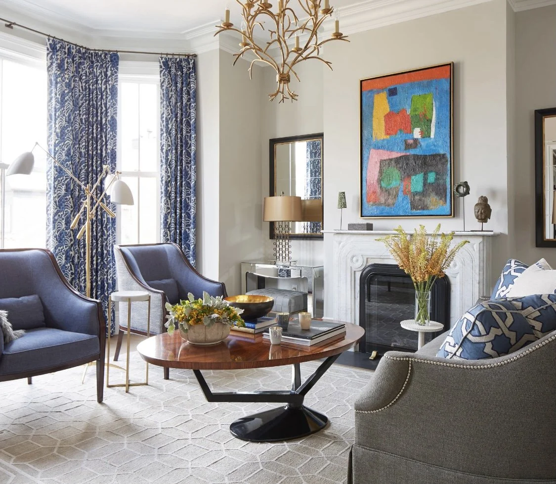 Modern living room with blue chairs.
