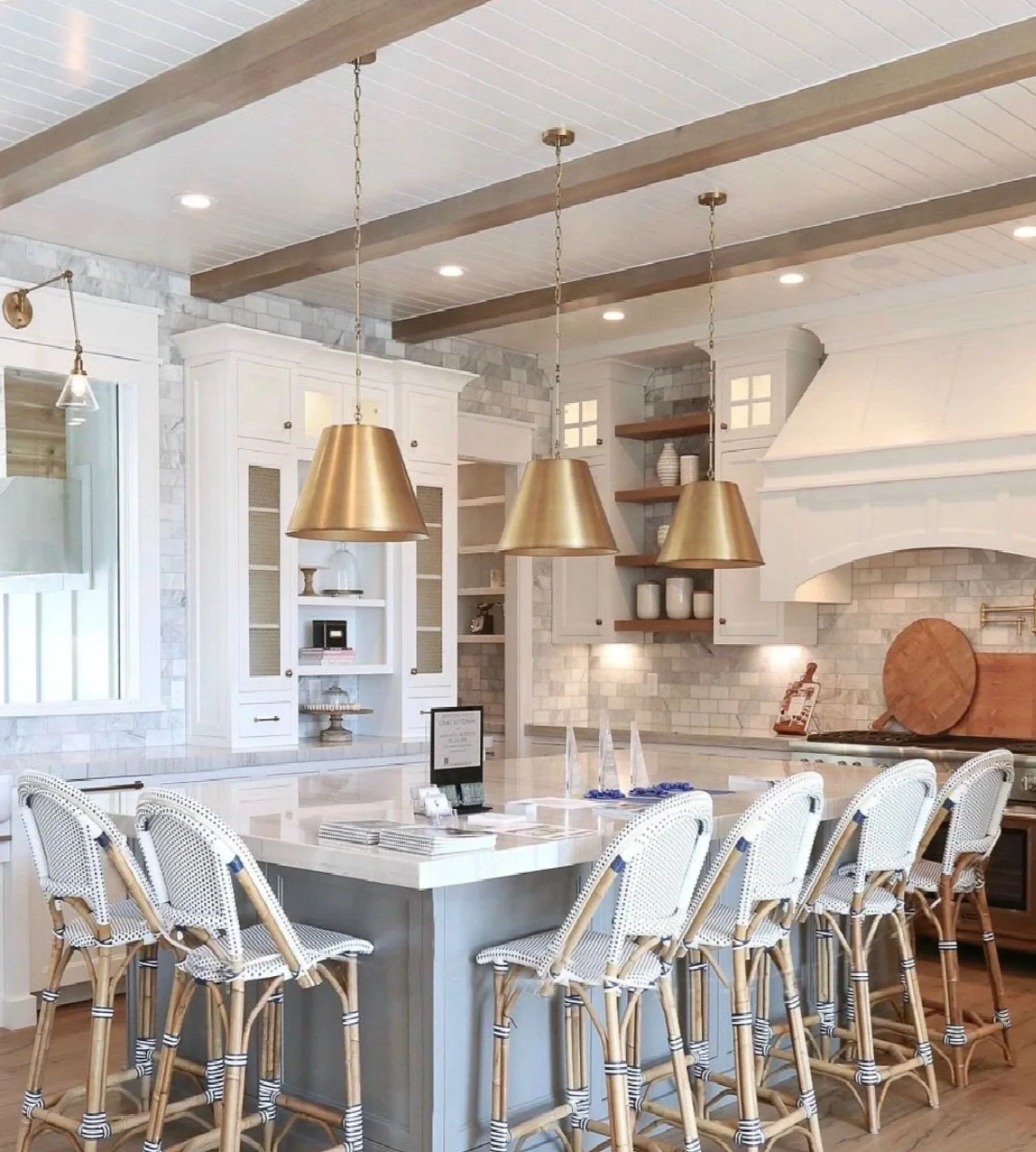 adrienne-morgan-interior-design-dallas-tx-wood-accents-in-home-design-large-kitchen-with-exposed-wood-beams-island-with-bar-stools-brass-pendants-comfort.jpg