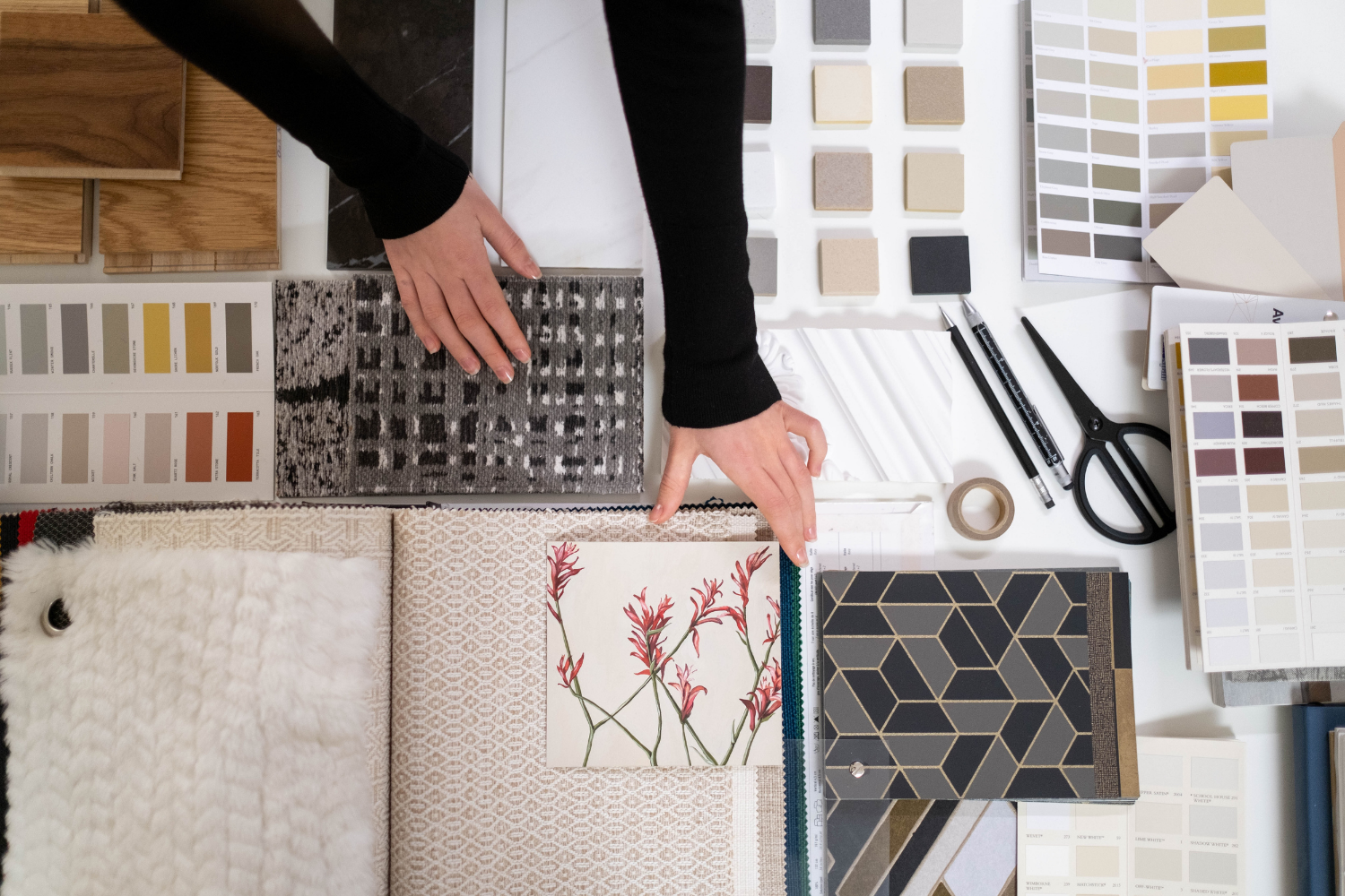 Interior Designer laying out fabric and tile samples.
