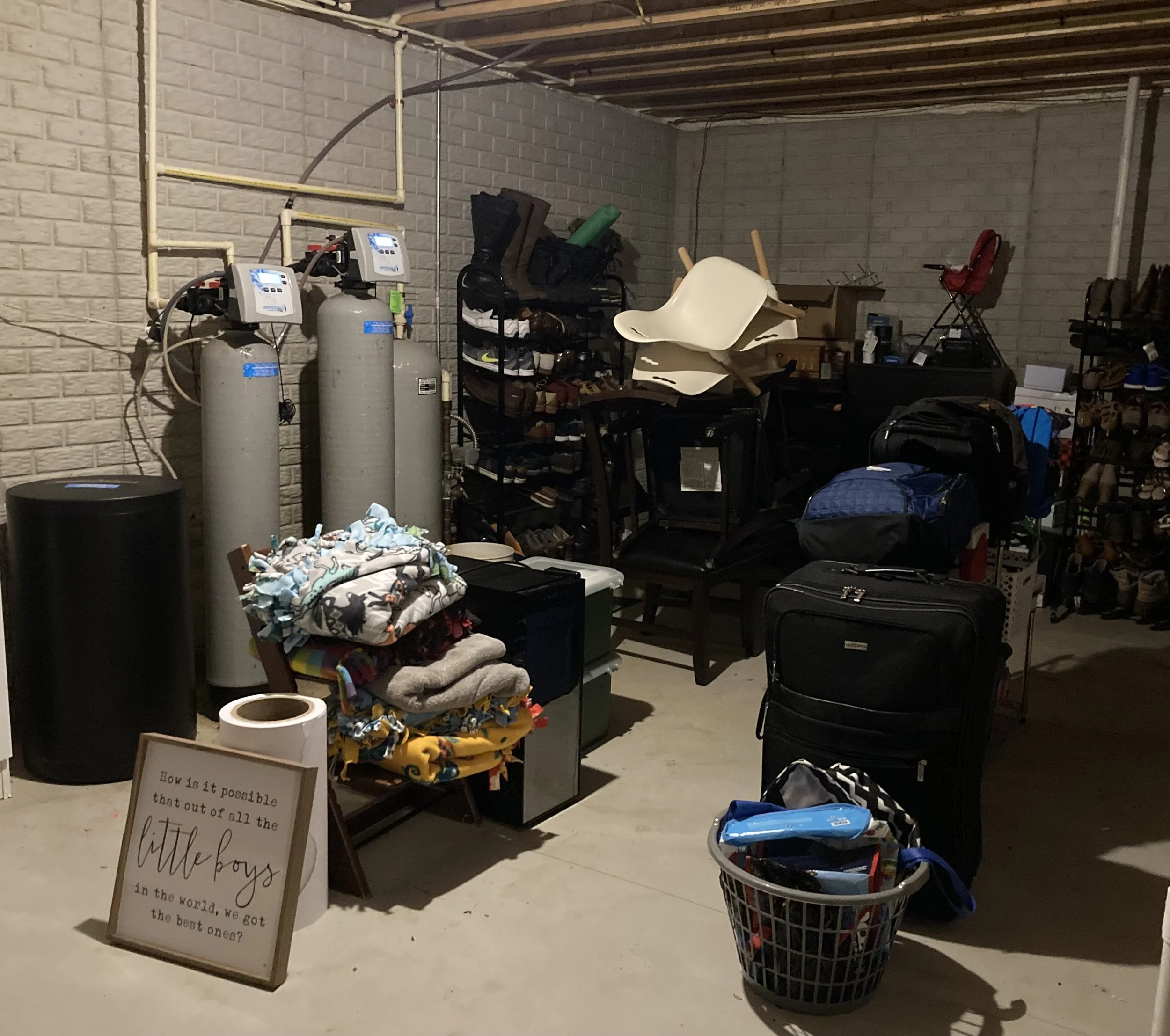 This is an after photo of a basement. We found luggage, dog rescue supplies, kids crafting items, and prepared the space for the family to move through donations and equipment.