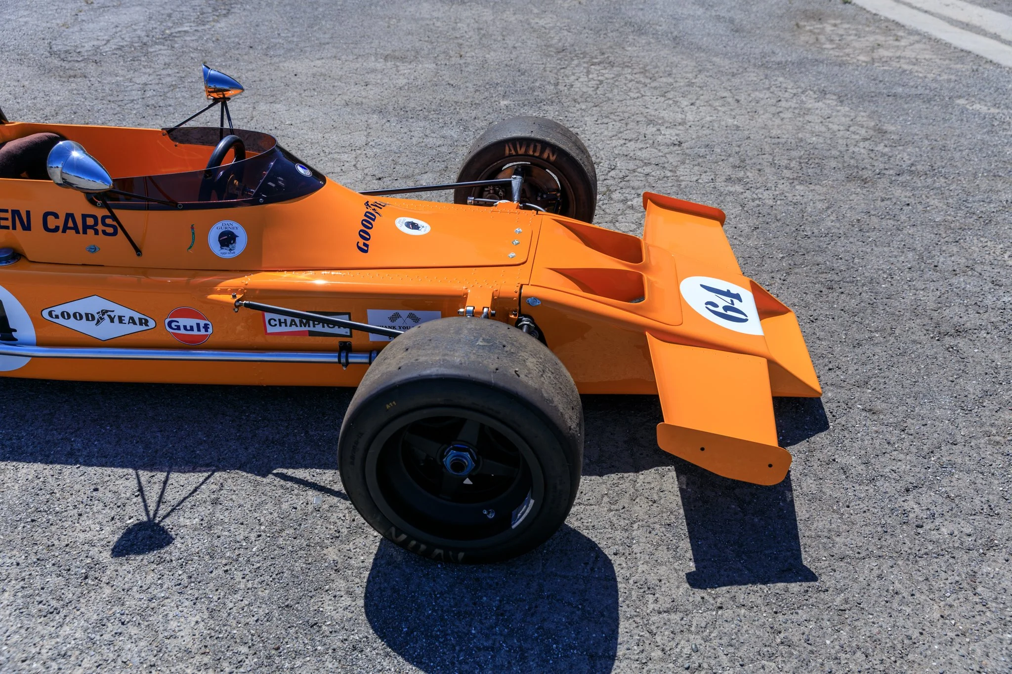 McLaren M21 Formula 2, chassis M21-3, Papaya Orange — three-quarter front view from above, right side, race number 64, Sonoma Raceway